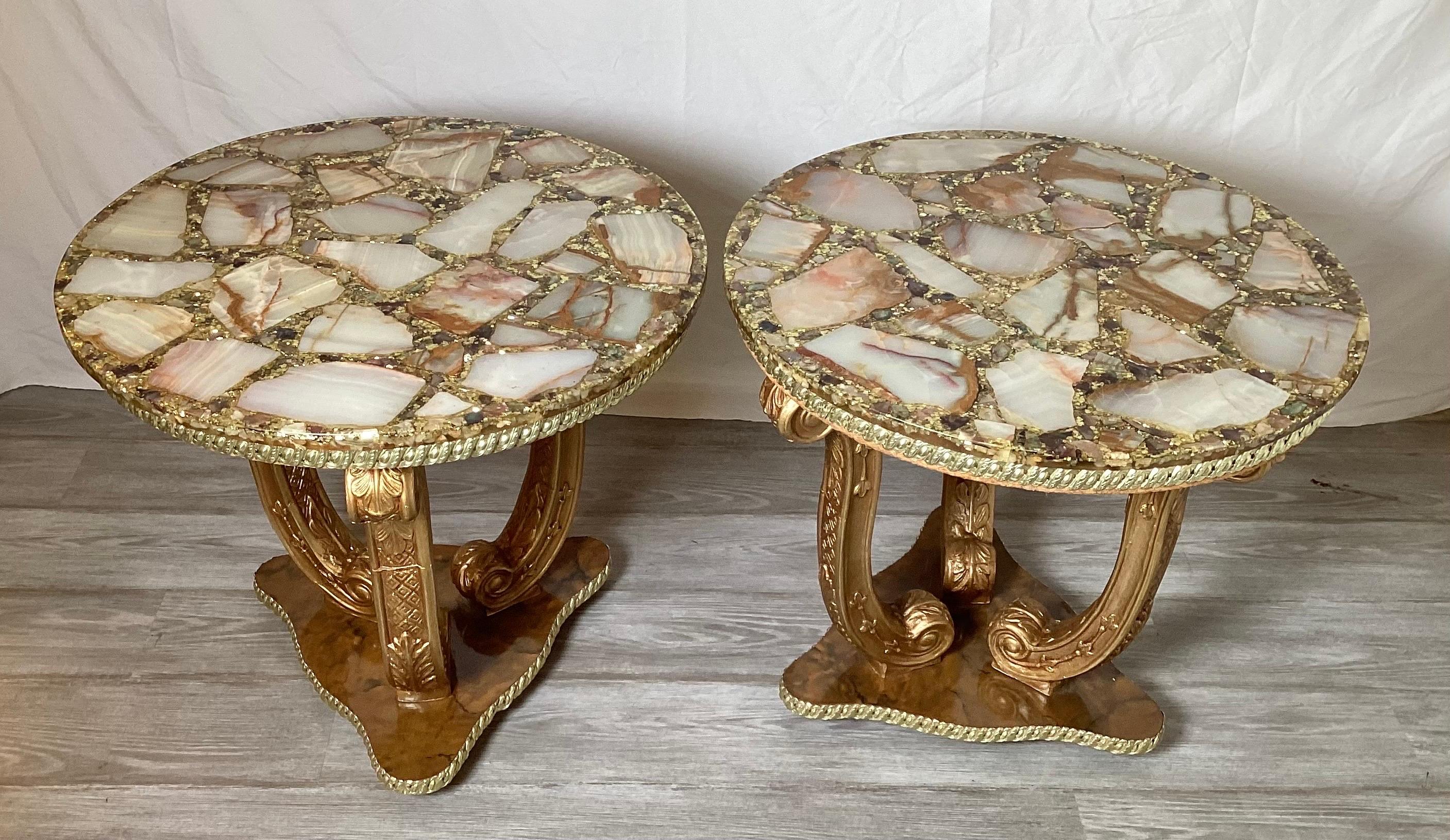 A pair of round gilt wood side tables By Arturo Pani with unusual onyx and abalone shell tops. The tops with a mosaic of onyx, shell, gold glitter and resin with three metal gilt scrolled legs on a tripod base. These can be used in front of a sofa