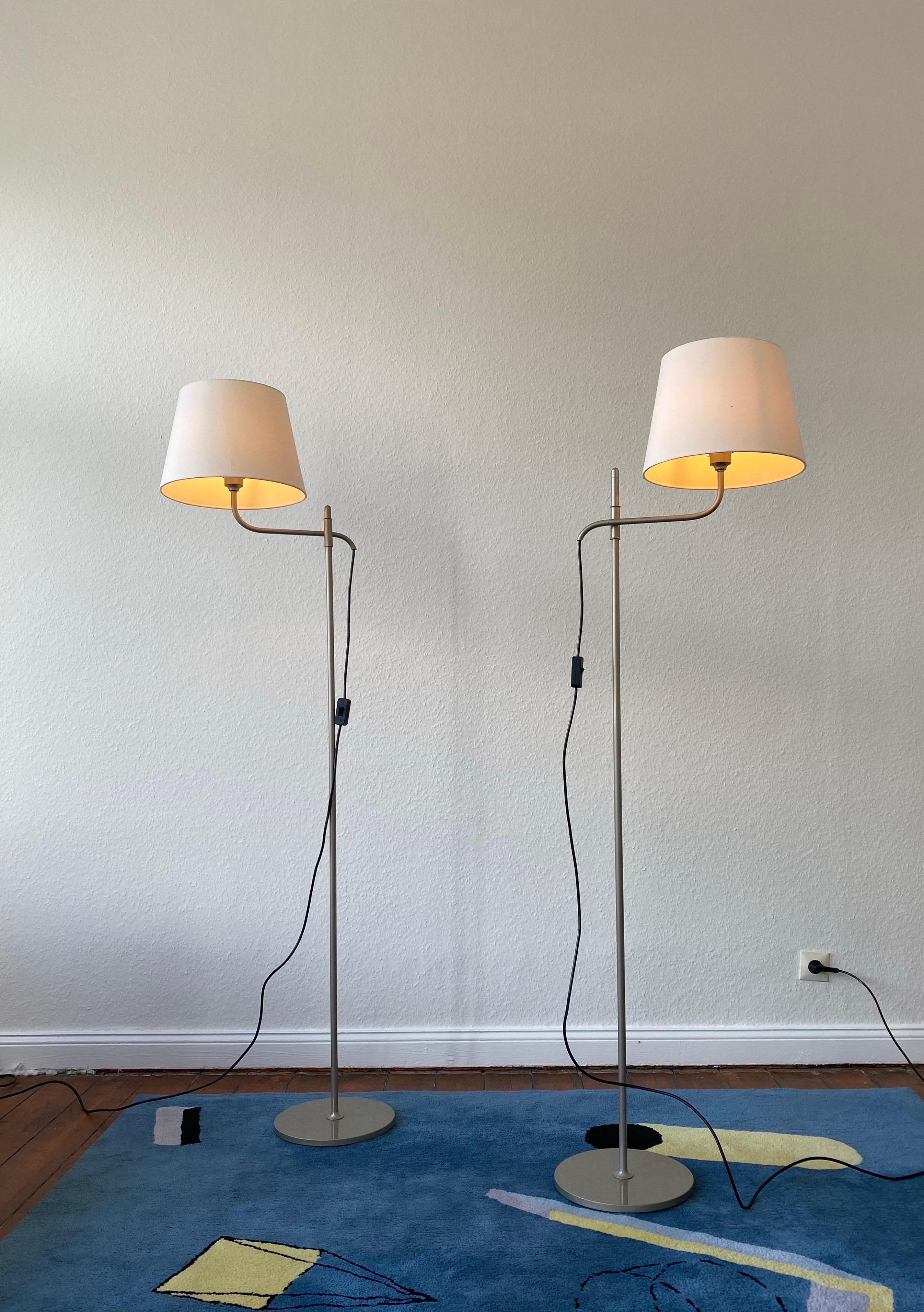 Un par de latón niquelado ajustables  alta calidad  y elegantes lámparas de pie ,
Modelo : STE de Florian Schulz, diseñado en los años 70 en Alemania.

Con su bonito acabado en níquel patinado, estas lámparas regulables son muy flexibles para crear