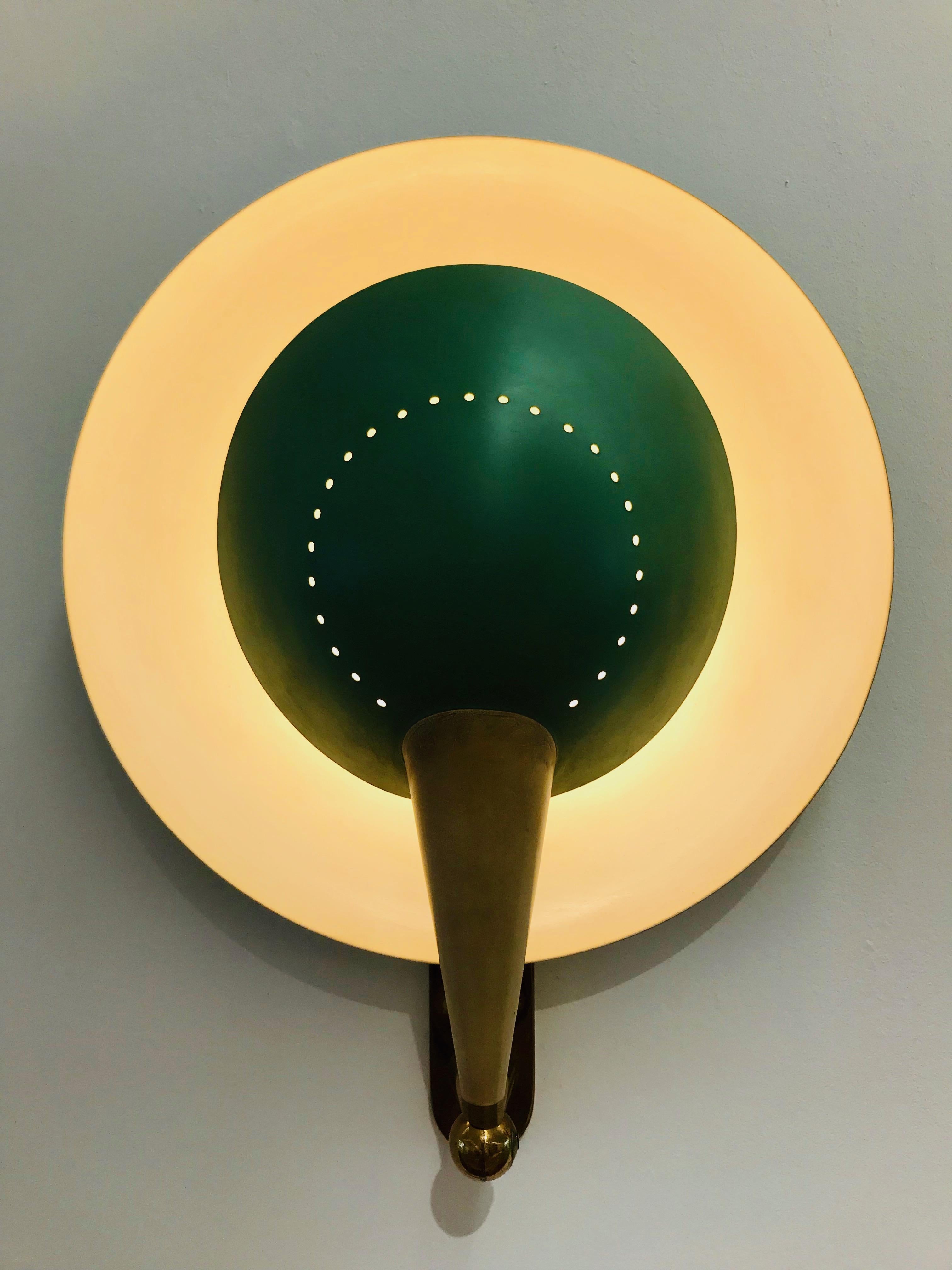 A pair of rare model no. B 4917 sconces by Stilnovo, manufactured in Italy, circa 1950s. 

- Brass, painted steel
- Adjustable shade
- Very good vintage condition, with minor signs of usage
- Produced by Stilnovo, Milan, Italy
- circa 1950s
-