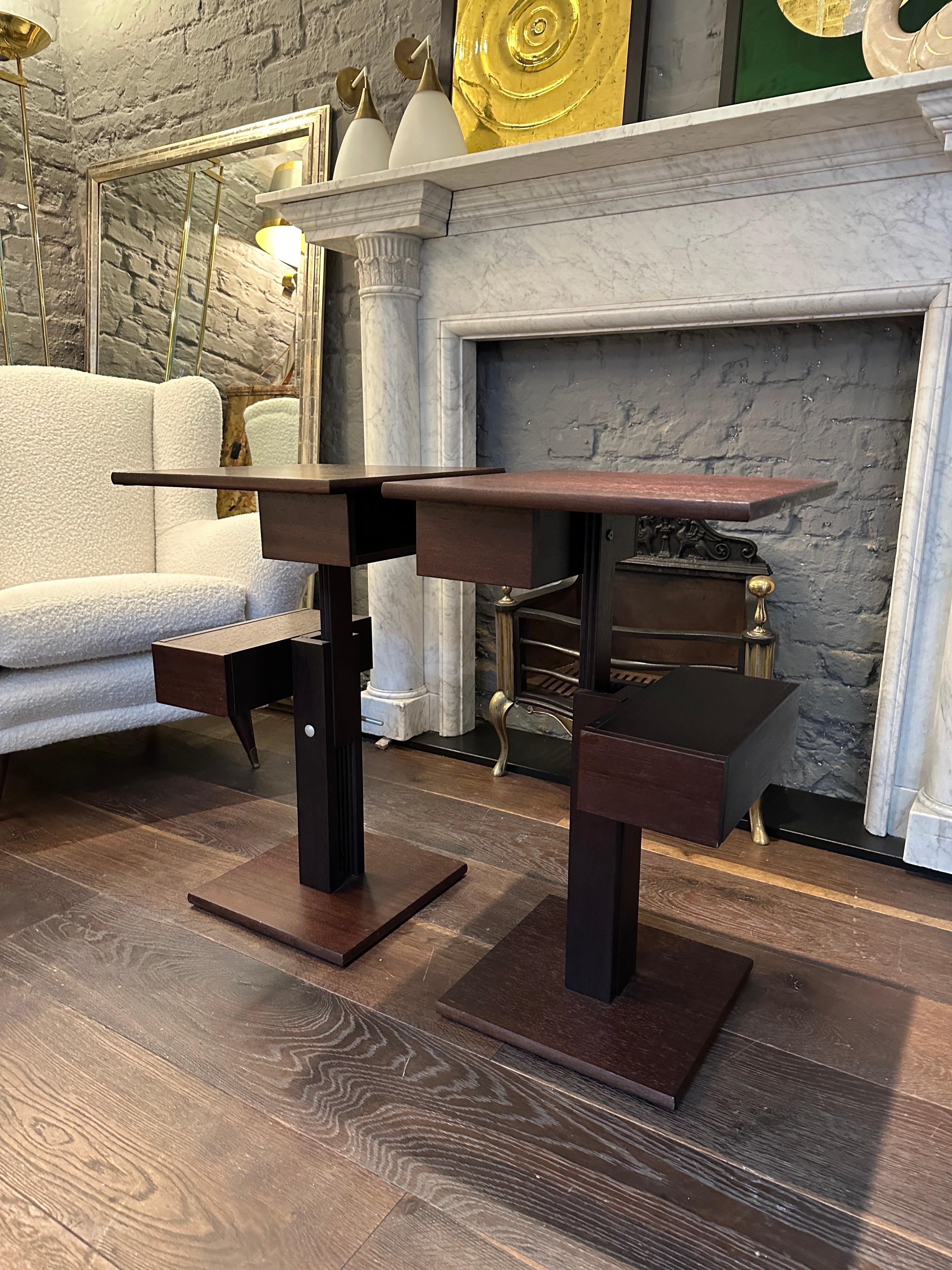 A pair of height adjustable side, end or bedside tables with two storage compartments on each. The height at full extension is first image is adjusted by leaver at the back. 

Parisian designer and Engineer Bernard Vuarnesson created furniture
