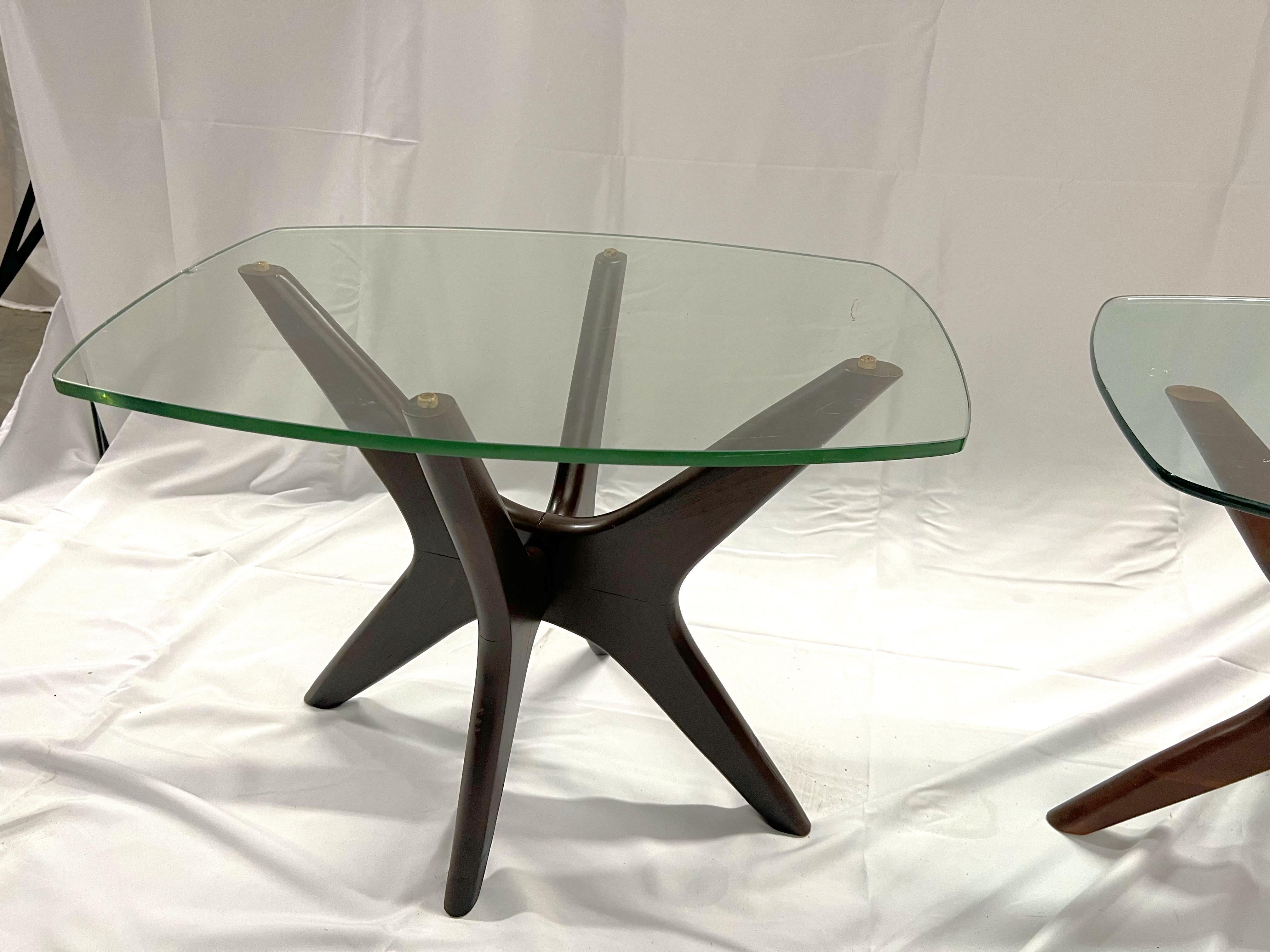 A pair of walnut and glass Pearsall side tables known to the profession as the 