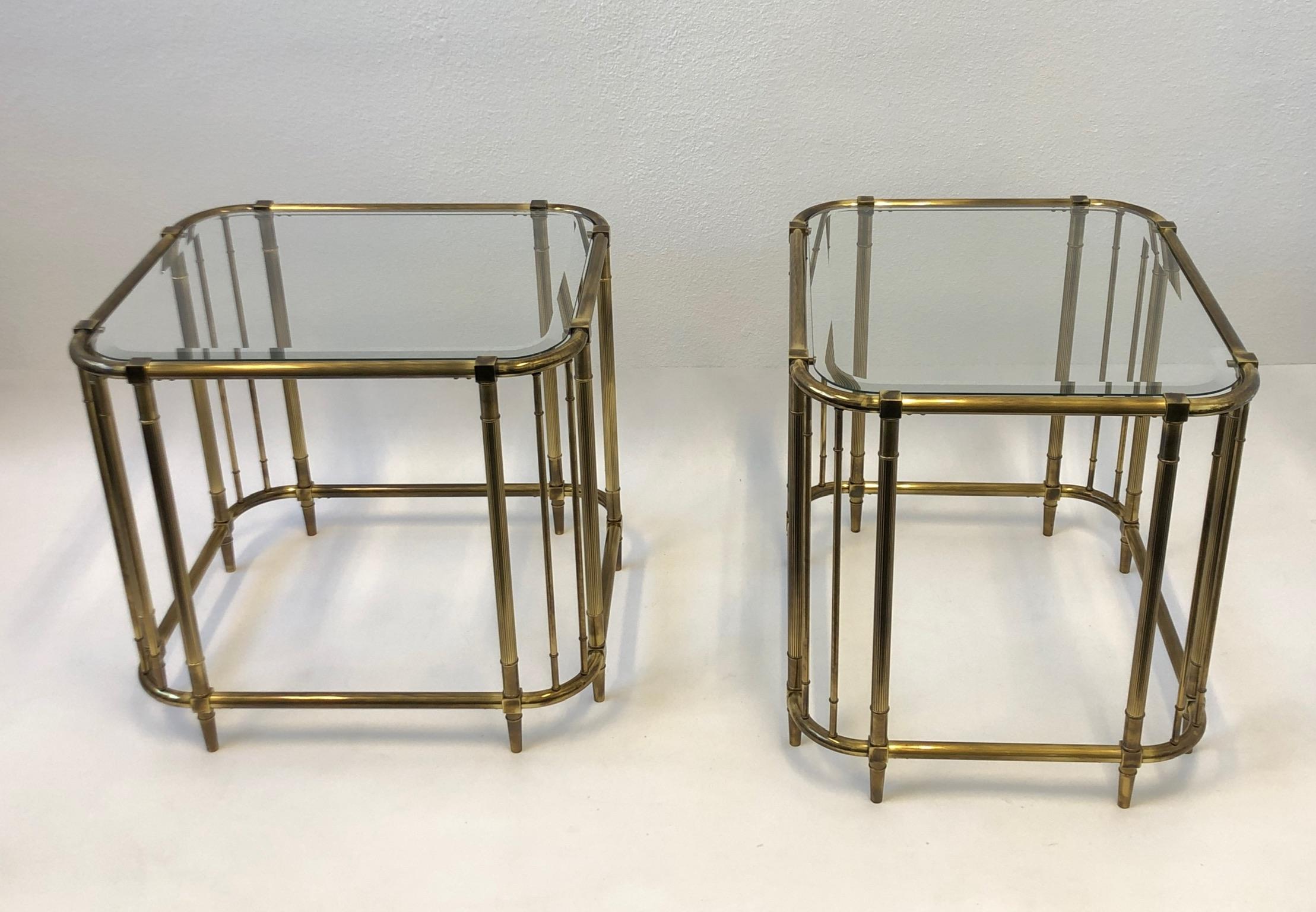 Rare pair of solid brass and beveled glass side tables designed by Mastercraft in the 1970s. The tables retain the original aged brass finish that Mastercraft is known for (see detail photos). This can be used as nightstand if