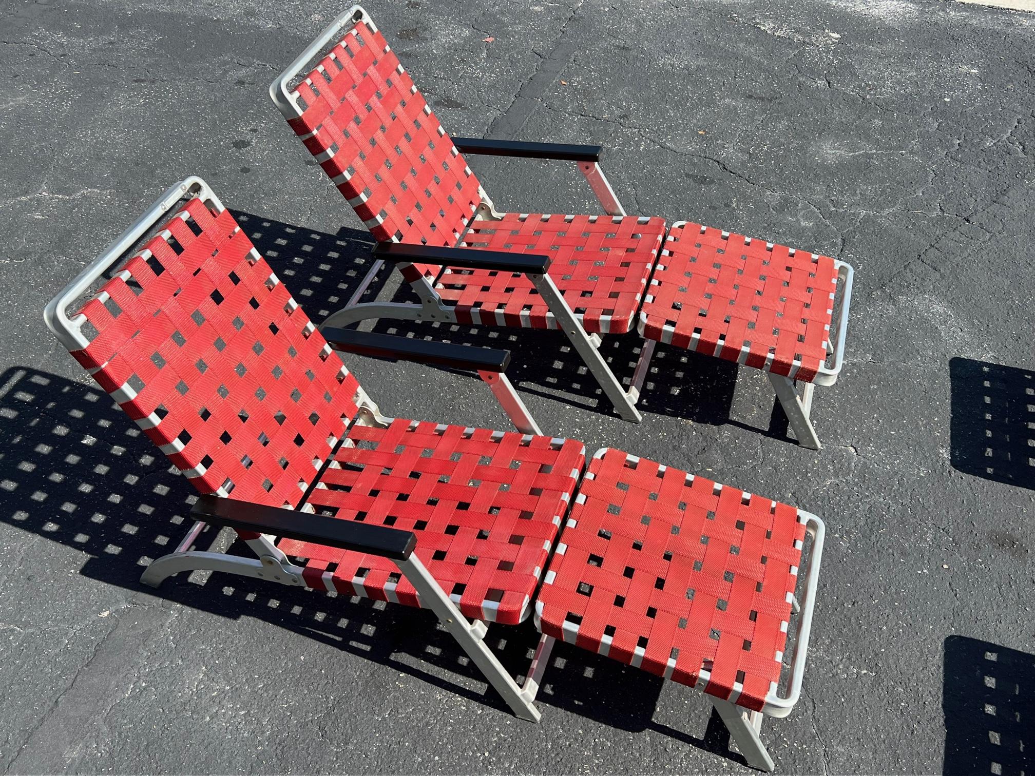 A pair of rare aluminum chaise lounges from famed luxury liner SS United States, ca' 1950's. Interesting folding design, red plastic straps. A total of four available. Priced $1,900 each or $3,500 per pair.