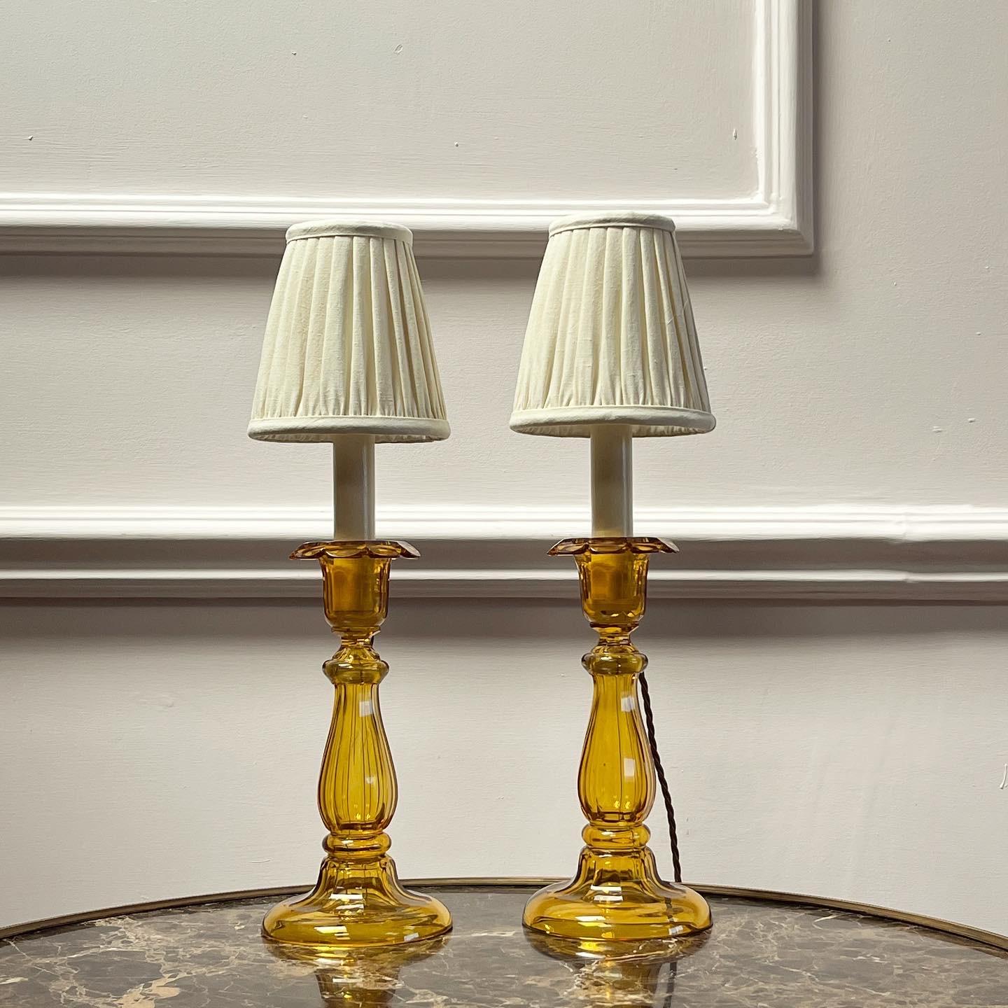 A pair of baluster formed hand blown amber glass candlesticks, now as lamps.
 English, late 19nth century.