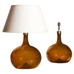 A Pair Of Amber Glass Vessels As Lamps 