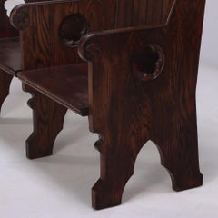 A Pair of American Gothic style carved oak double benches, C 1900.