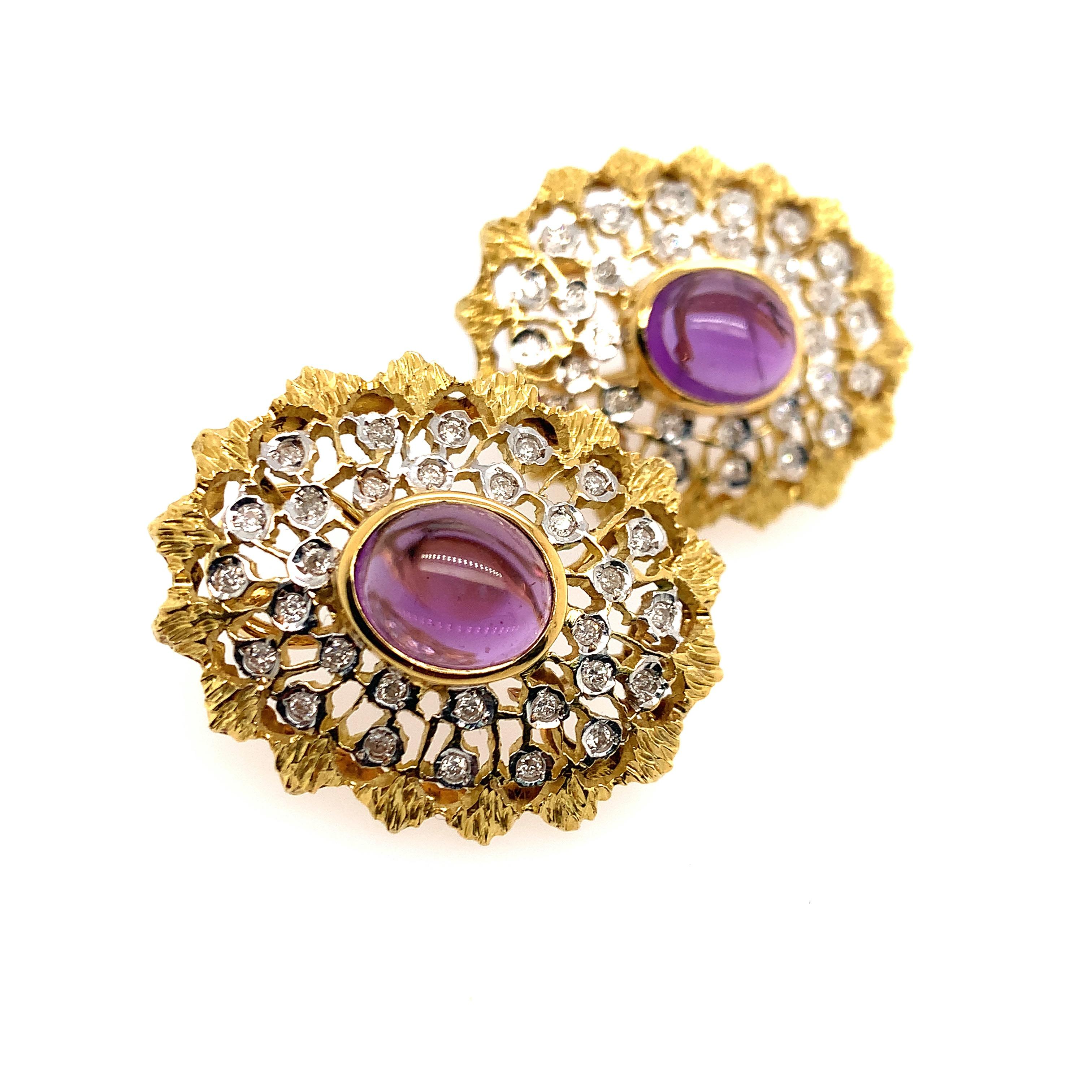 The large oval forms set with a pair of cabochon amethysts weighing approximately 8.00 carats, amid textured and pierced surrounds accented by round diamonds, in 18k white and yellow gold

Weight: 23.6 grams
Earrings measuring 27 x 34 mm
Diamonds