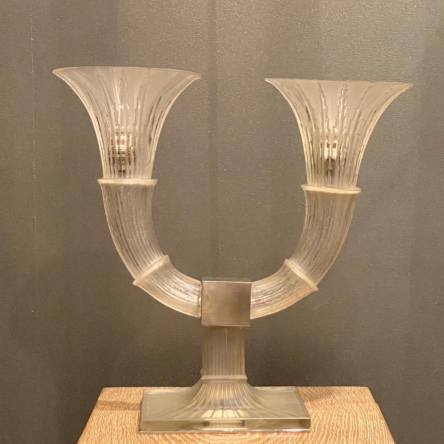 The Amsterdam candelabras or lamps are an iconic design which R.Lalique made in 1932.

Not many lamps have outlived their time as often the shades are broken .

A glass lamp is extremely fragile and lalique did conceive his lamps in glass , with a