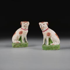 A Pair of Anglo-Chinese Painted Terracotta Recumbent Spaniels