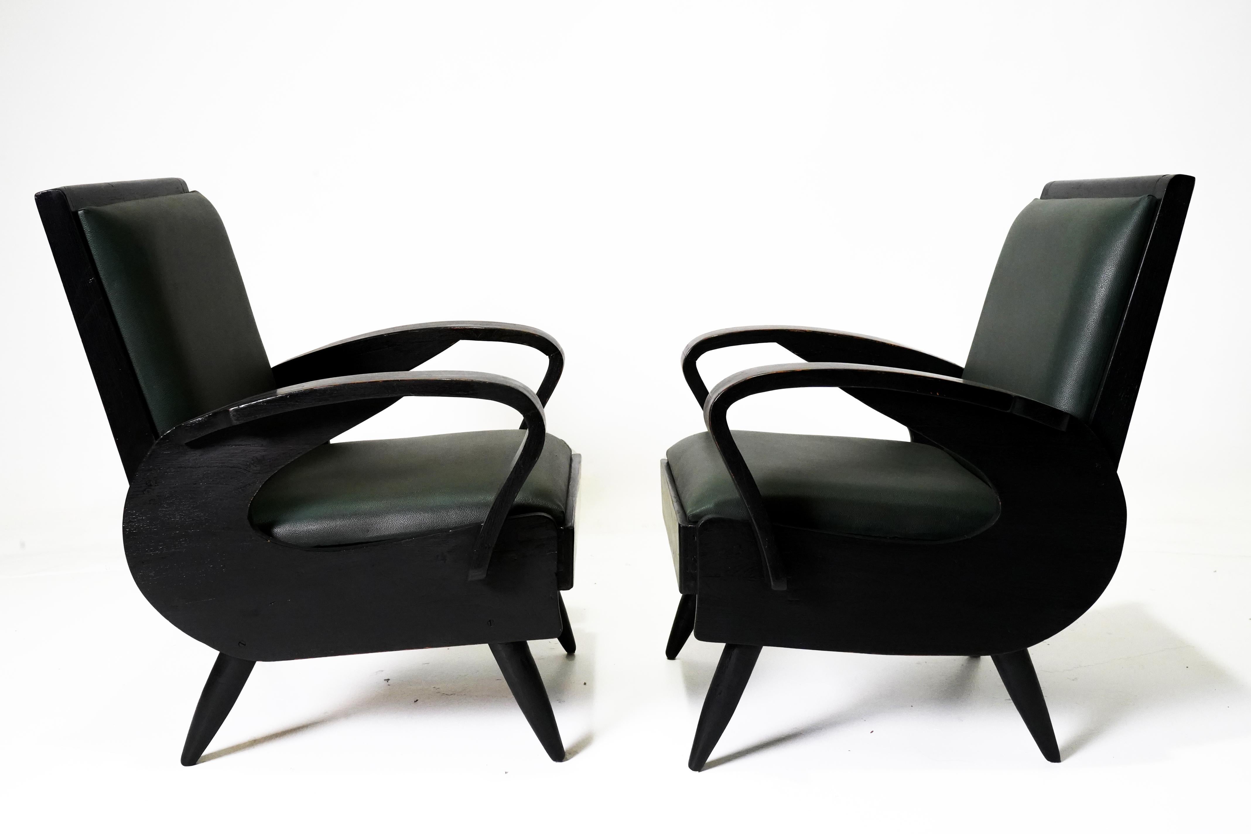 These Anglo-Indian lounge chairs date to the early 1950's and were made in the Mid-Century style.   During the British Colonial period and in the two decades after independence, much Indian furniture was made following British or European styles. 