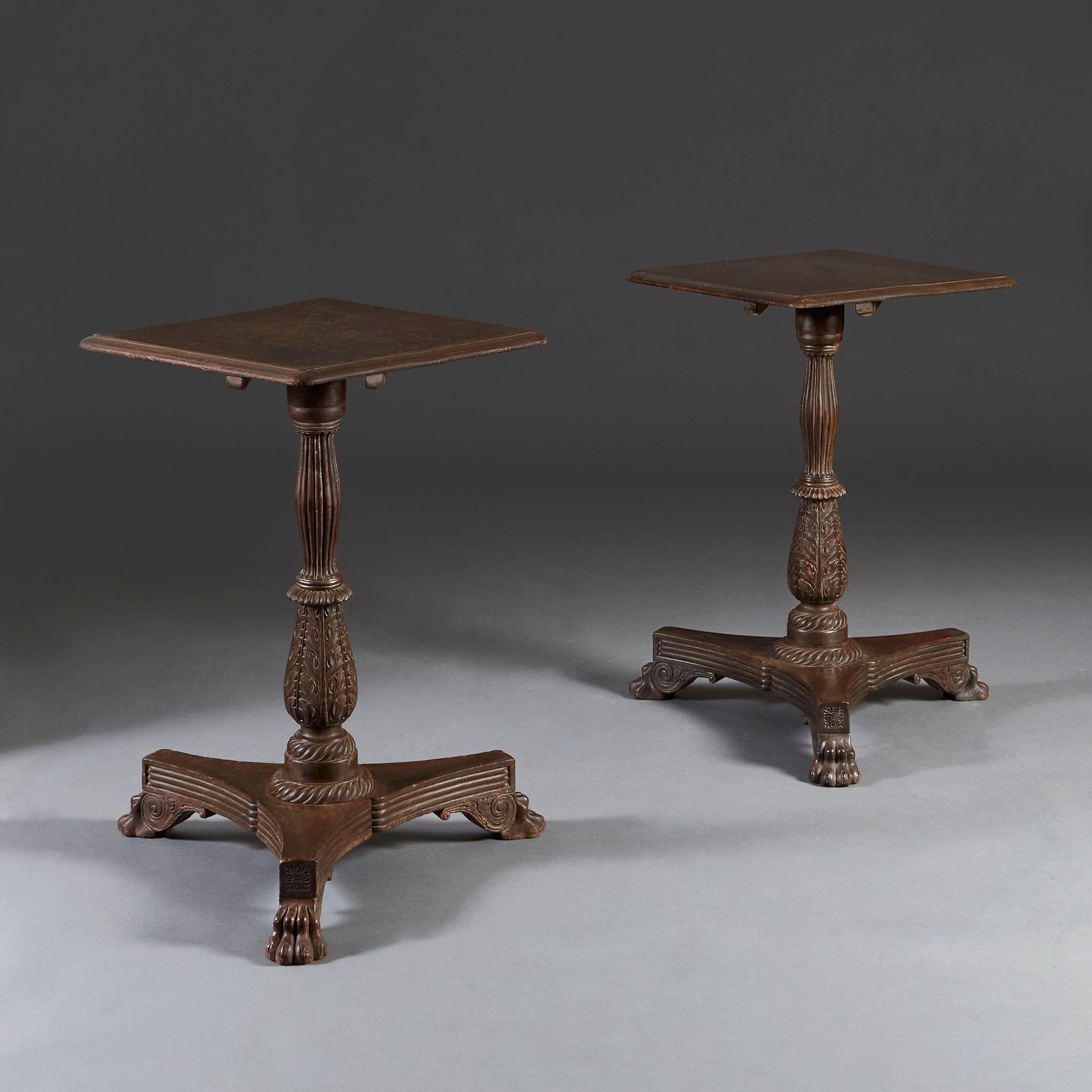 An unusual pair of early 19th century Anglo Indian occasional tables with square tops supported on a turned pedestal, with triform bases, ending in hairy paw feet.
 