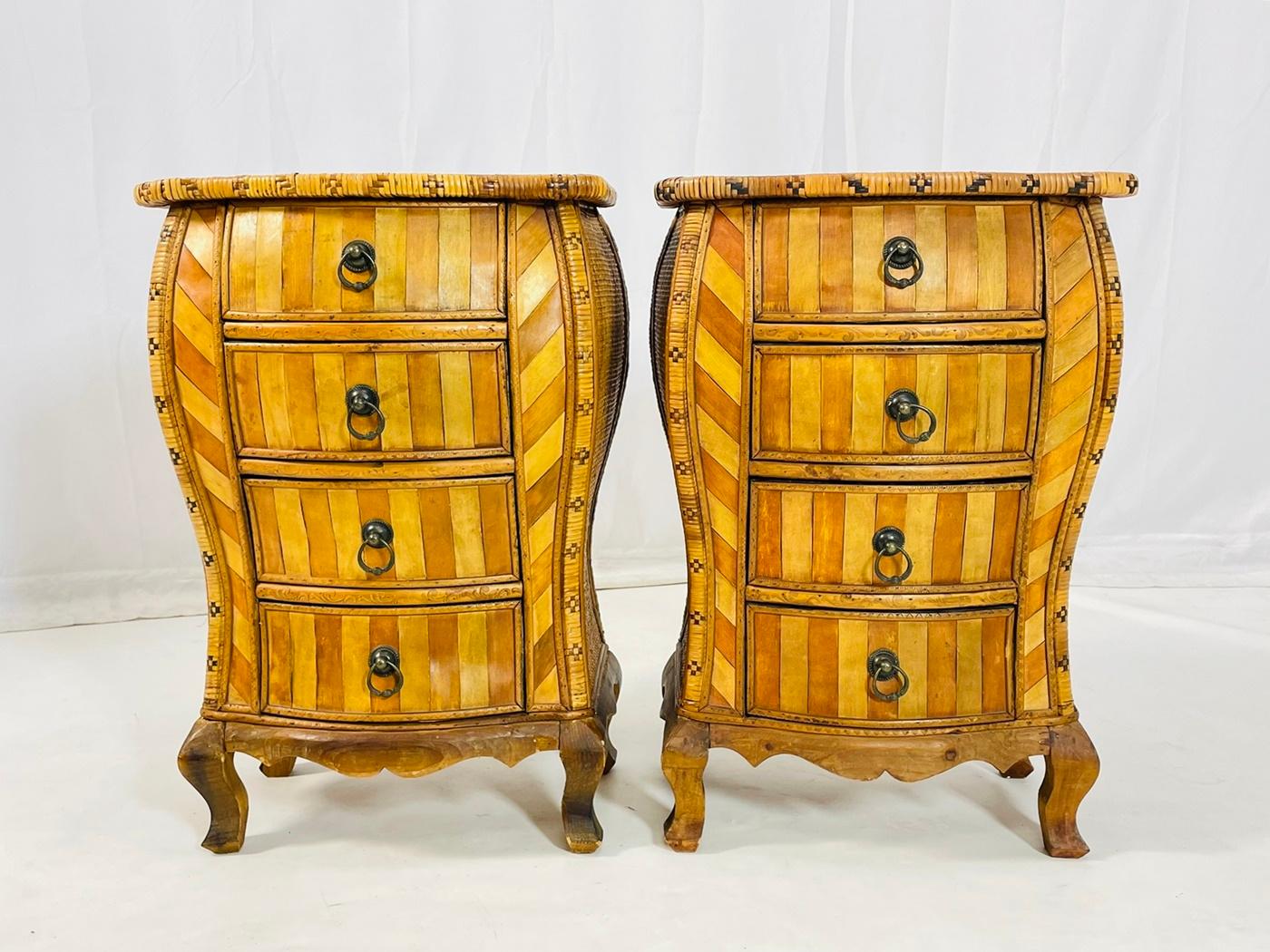 Stunning pair of bedside cabinets or nightstands designed and manufactured in the United States in the 1950s.

Having serpentine tops over four graduated drawers made with exotic wood inlay and weaved rattan to the canted corners and sides, raised