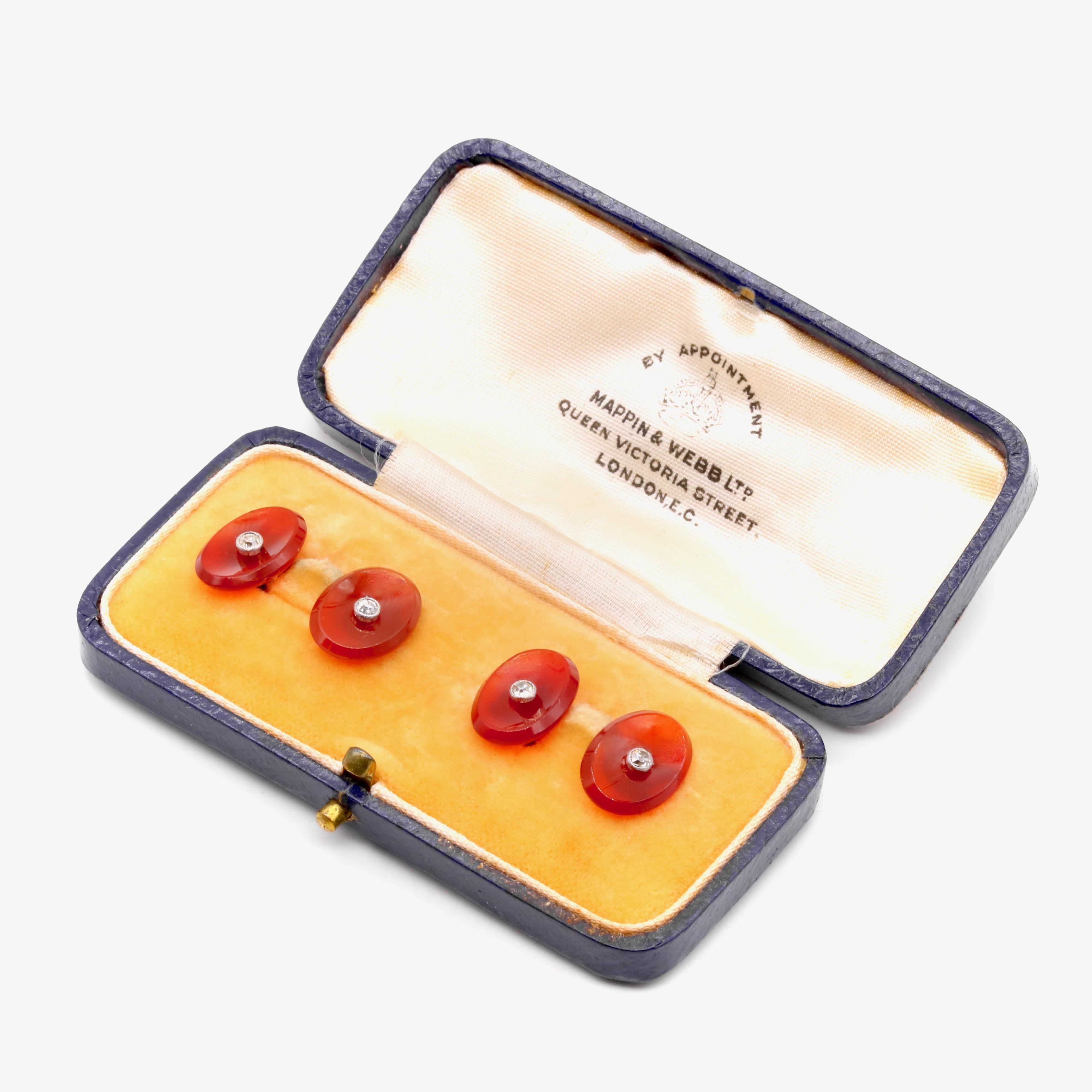 A pair of antique diamond, carnelian, platinum, and yellow gold cufflinks, each cufflink face comprising an old European cut diamond, and panel of carnelian, in 14 karat yellow gold and platinum. 

These unusual antique cufflinks are formed as oval