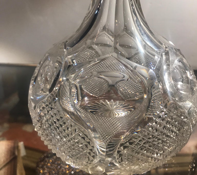 An exceptional pair of antique English decanters with original stoppers. The bottle form with precision hand cut details with panel cut necks. These are skillfully cut by a master cutter with sharp and crisp all-over decoration.