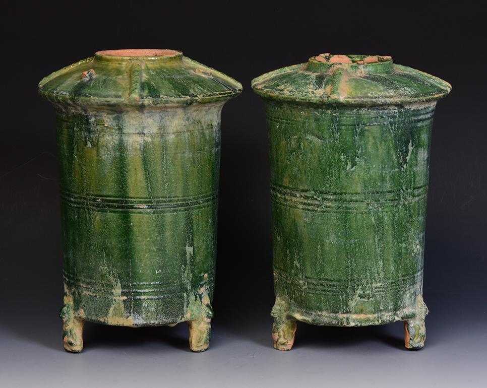 A pair of Chinese green glazed pottery granary jars with bear-shaped legs.

Age: China, Han Dynasty, 206 B.C. - A.D. 220
Size: Height 27.7 - 28.2 C.M. / Width 18.7 - 19.5 C.M.
Condition: Well-preserved old burial condition overall with some