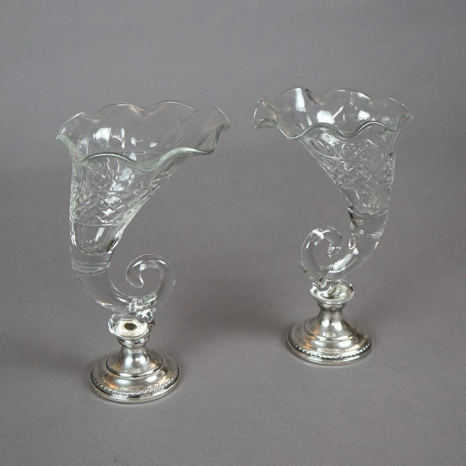 A pair of table vases offers cut glass in cornucopia form on sterling silver weighted based, circa 1920

Measures - 10.75