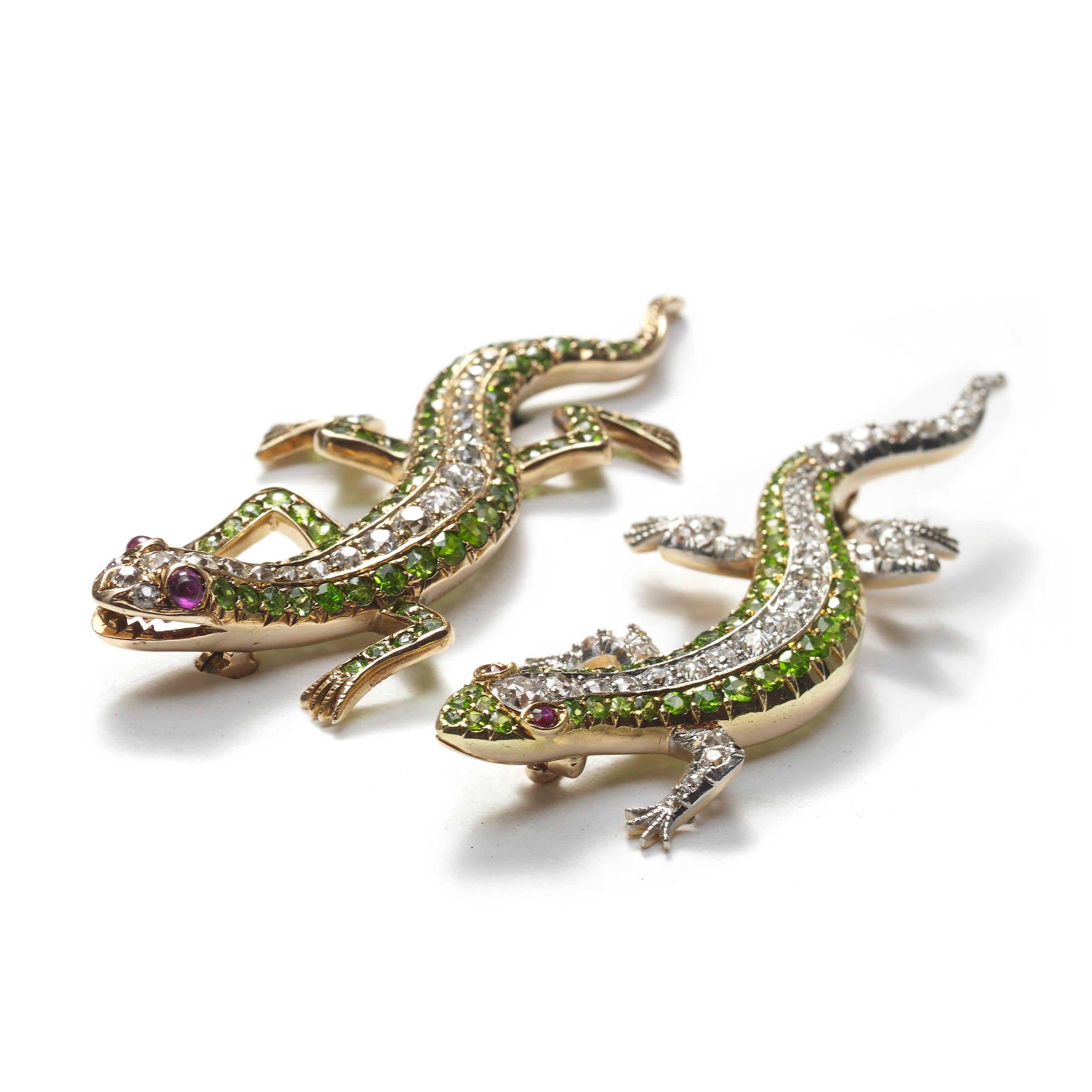 A pair of antique salamander brooches, each pavé set with demantoid garnets  in the legs, tail and sides, old-cut diamonds from the nose to the base of the tail, and round cabochon ruby eyes, mounted in 14ct yellow gold. Circa 1925.
Approximately