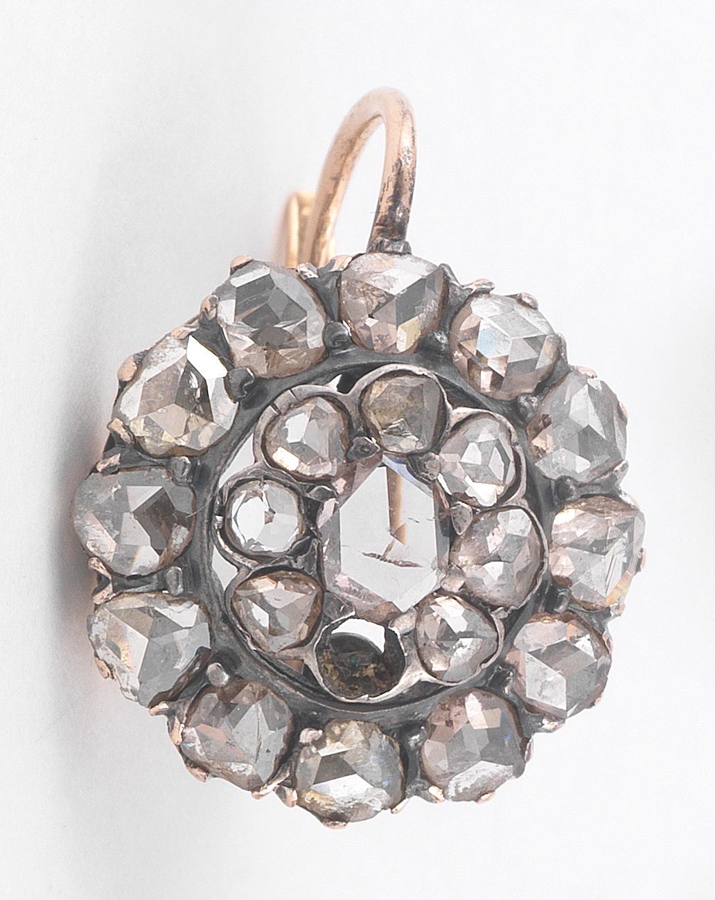 A cluster of rose-cut diamonds in a diamond surround; estimated total diamond weight: 3.50 carats; mounted in gold; diameter: 15mm