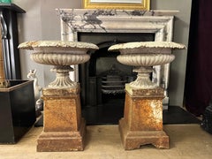 A Pair Of Antique English 19th Century Cast Iron Urns on Plinths