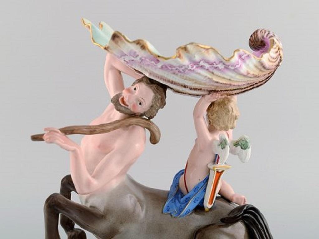 A pair of antique figurative Meissen compotes in hand-painted porcelain. Putti on a centaur carrying a large seashell. 
Museum quality. Dated 1815-1860.
Measures: 26 x 21 cm.
In excellent condition.
Stamped.
1st factory quality.
Provenance: