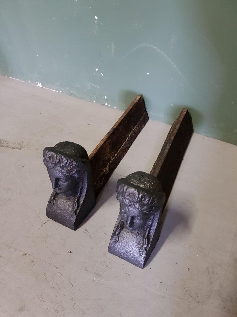 Cast Pair of Antique French Andirons with a Woman's Head, from the 19th Century For Sale