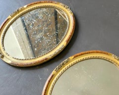 A Pair of Antique French Giltwood Oval Mirrors with Faux Tortoiseshell decoratio
