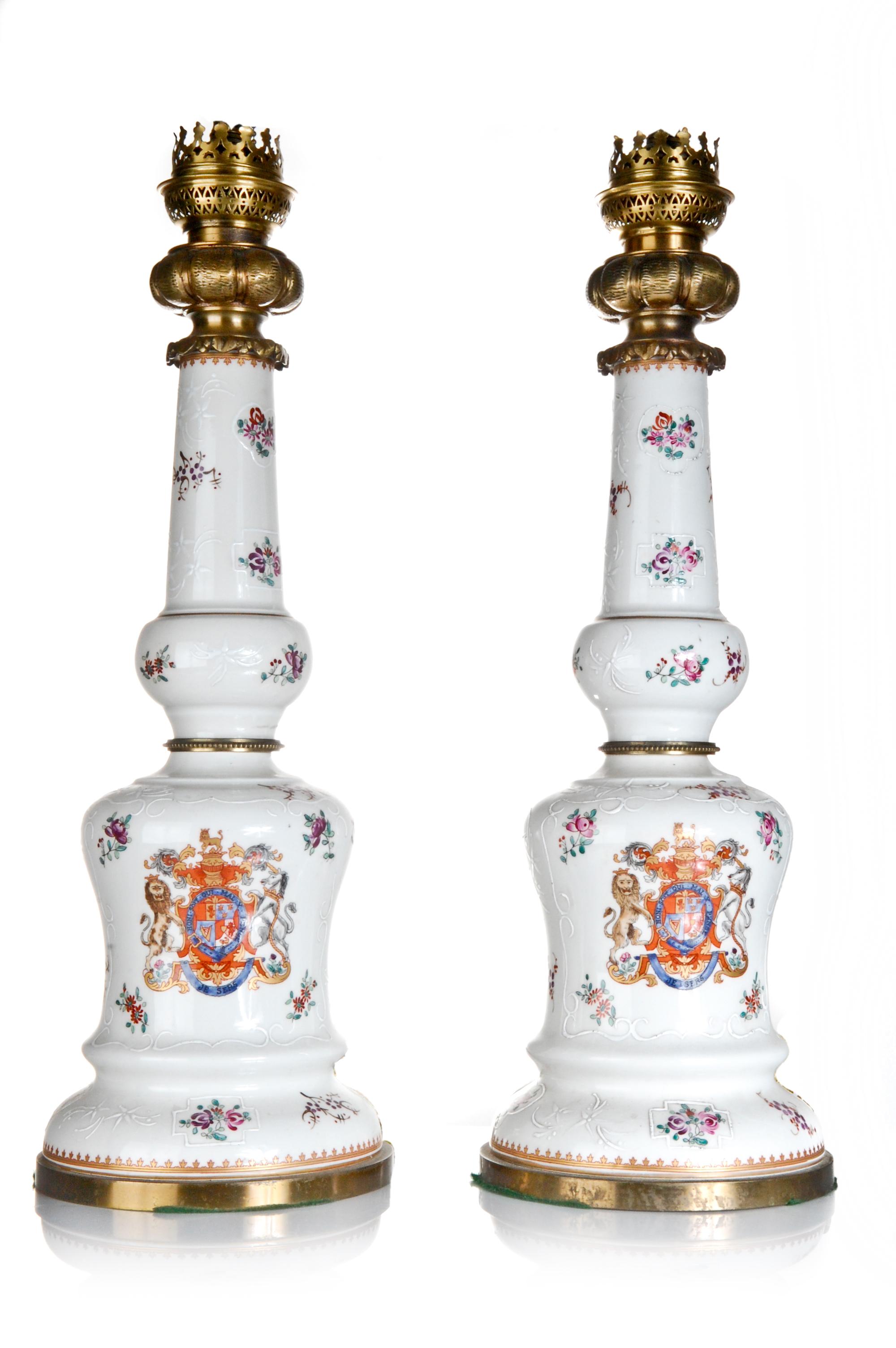 A Pair of Antique French Louis XVI Style Gilt Bronze mounted Samson Hand Painted Polychrome enameled Porcelain lamps with armorial crest and flowers.