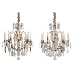 A pair of antique French silvered bronze and crystal chandeliers