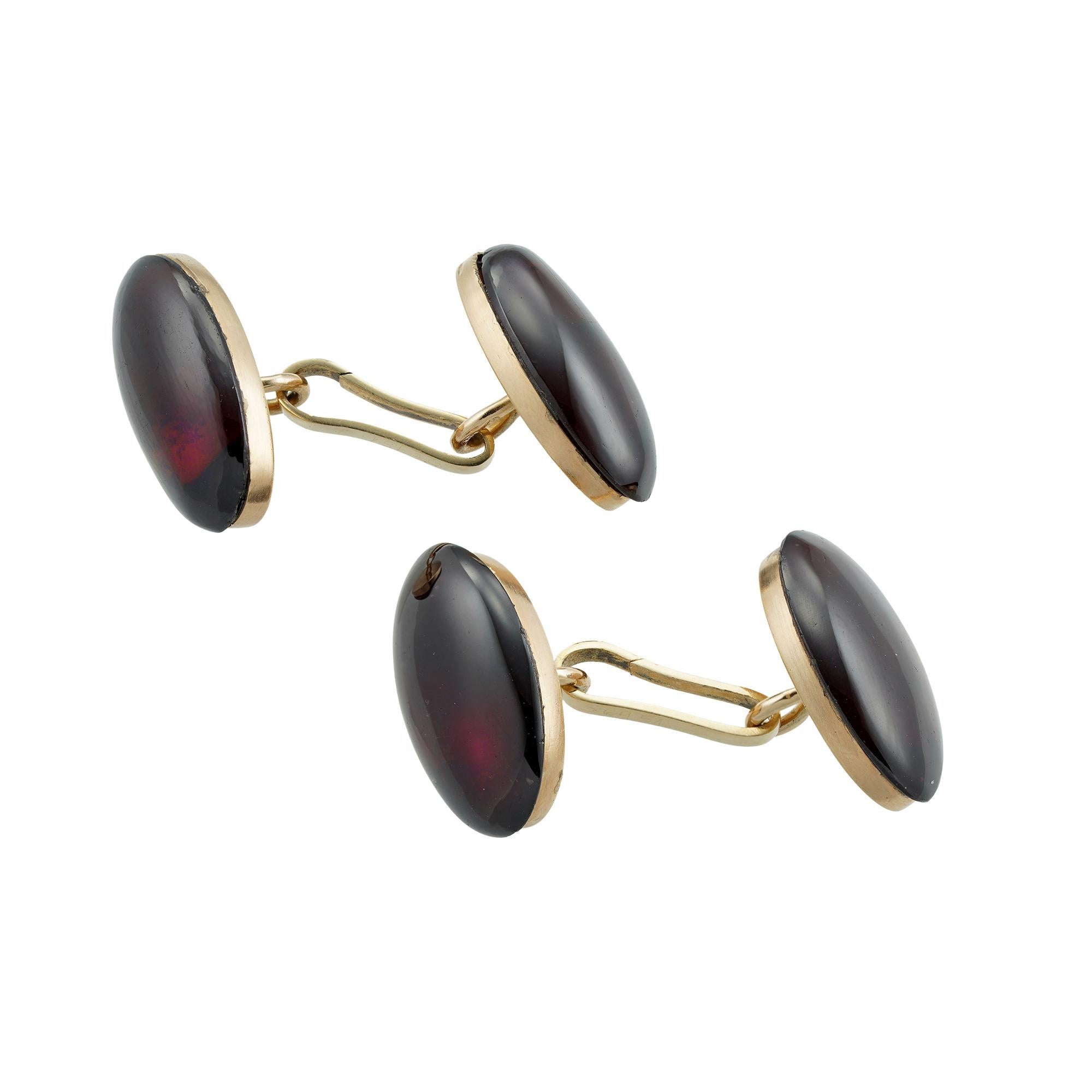 A pair of antique garnet cufflinks, each cufflink with two oval cabochon-cut garnets set in gold back and connected by clip fitting, bearing Austro-Hungarian hallmarks for 14ct gold, circa 1880, measuring approximately 2.2 x 1.2cm, gross weight 18.1