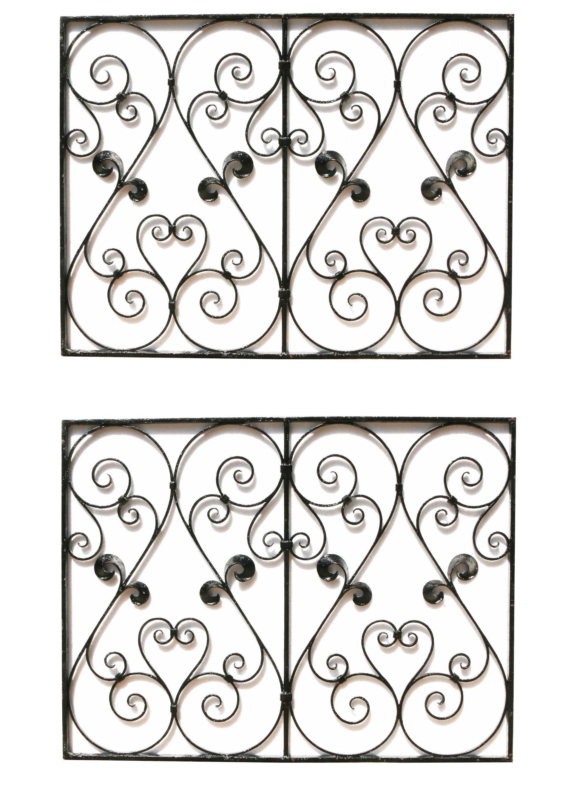 A pair of antique iron panels with a scrolling design. Salvaged from a London Townhouse.