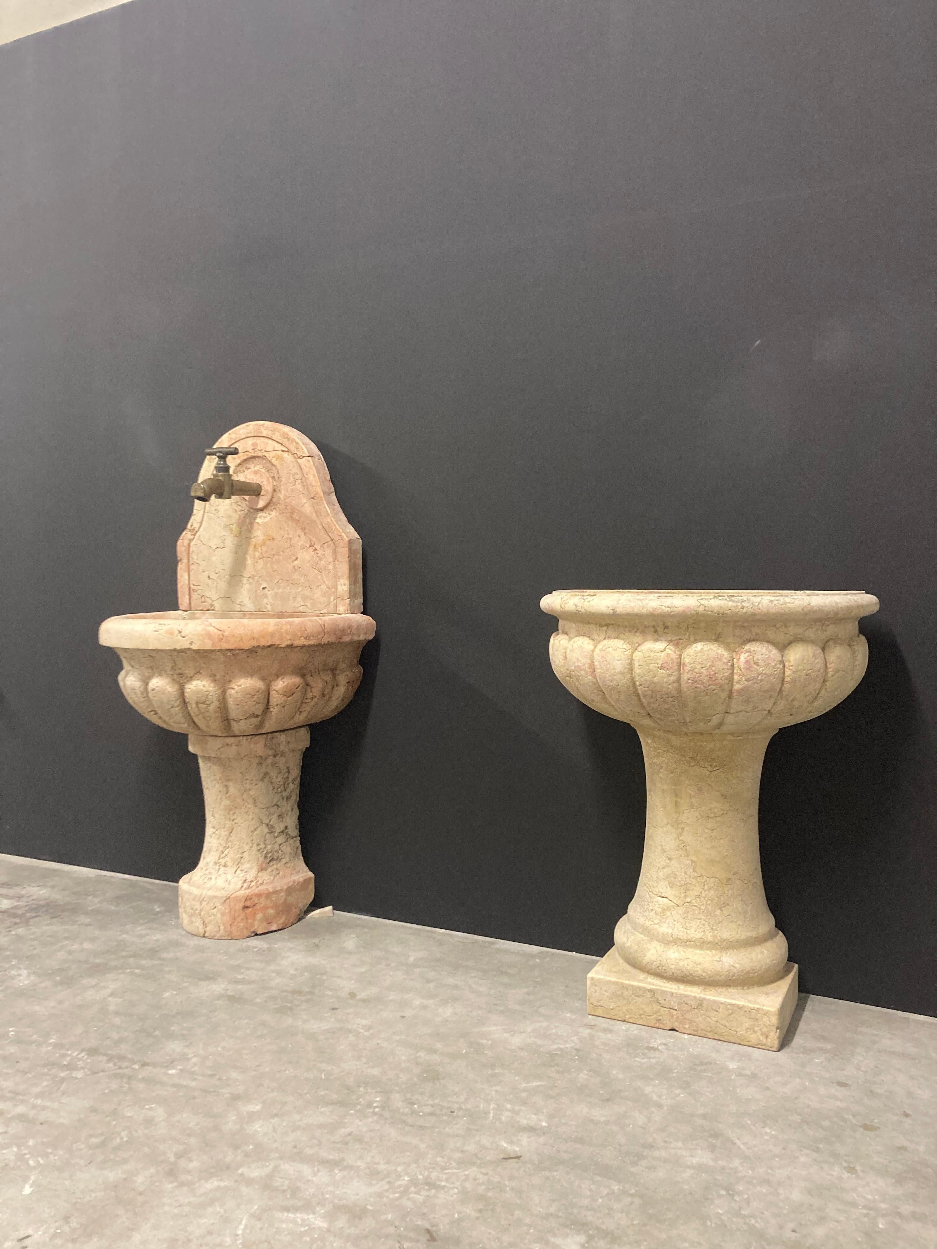 Happy to offer this great pair of Italian wall fountains.
These fountains date from the 19th century and are made from marble quarried in Verrone, Piedmont, Italy.

The left has a nice shaped backplate, both have strong shaped basins on rounded
