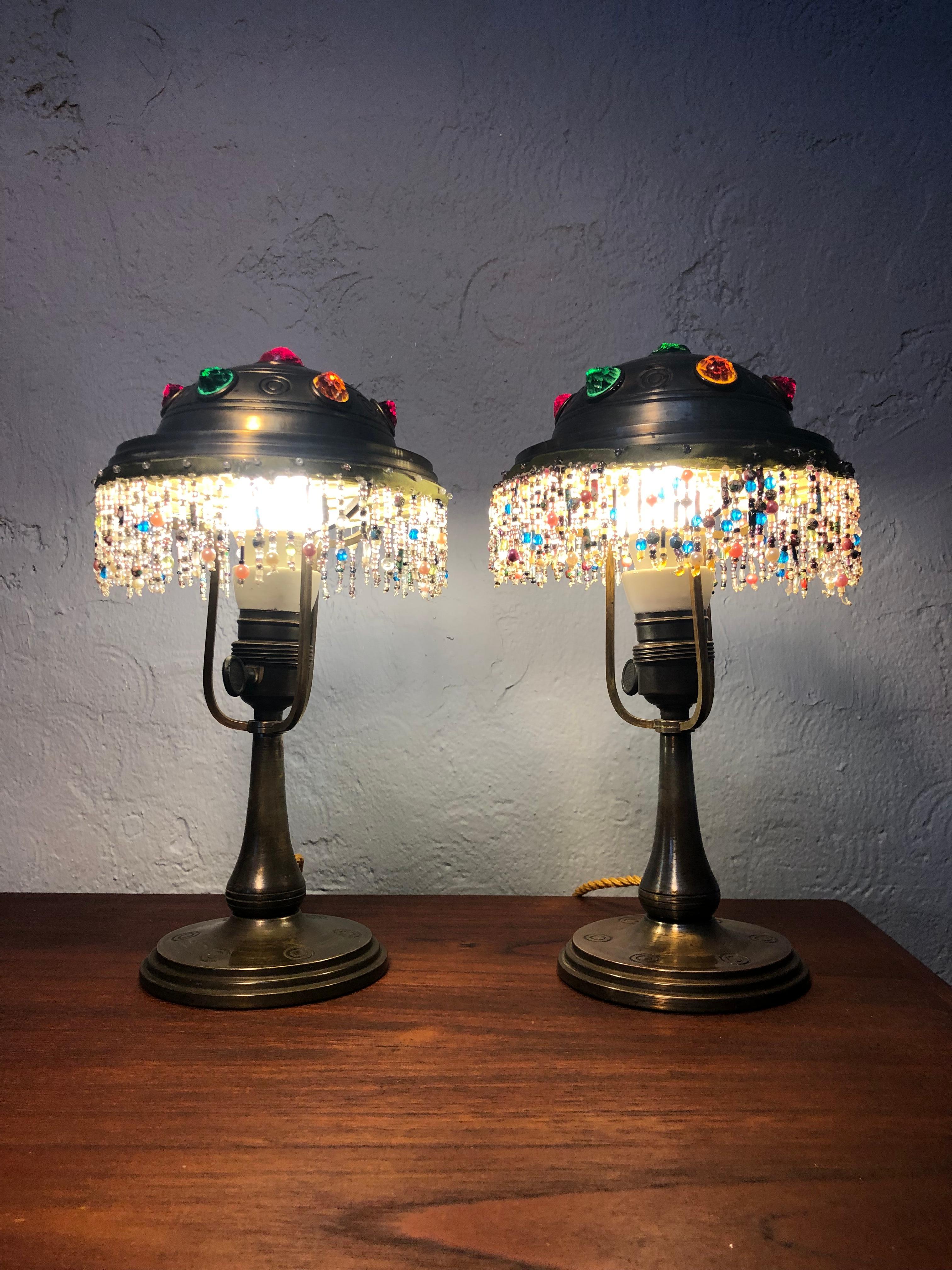 A Gorgeous pair of brass Jugend table lamps. 
Completely original condition from the glass beaded skirting on the brass shades to the glass cabochon pearls and also the brass and porcelain bulb holders with on/off switch. 
This pair of Jugend