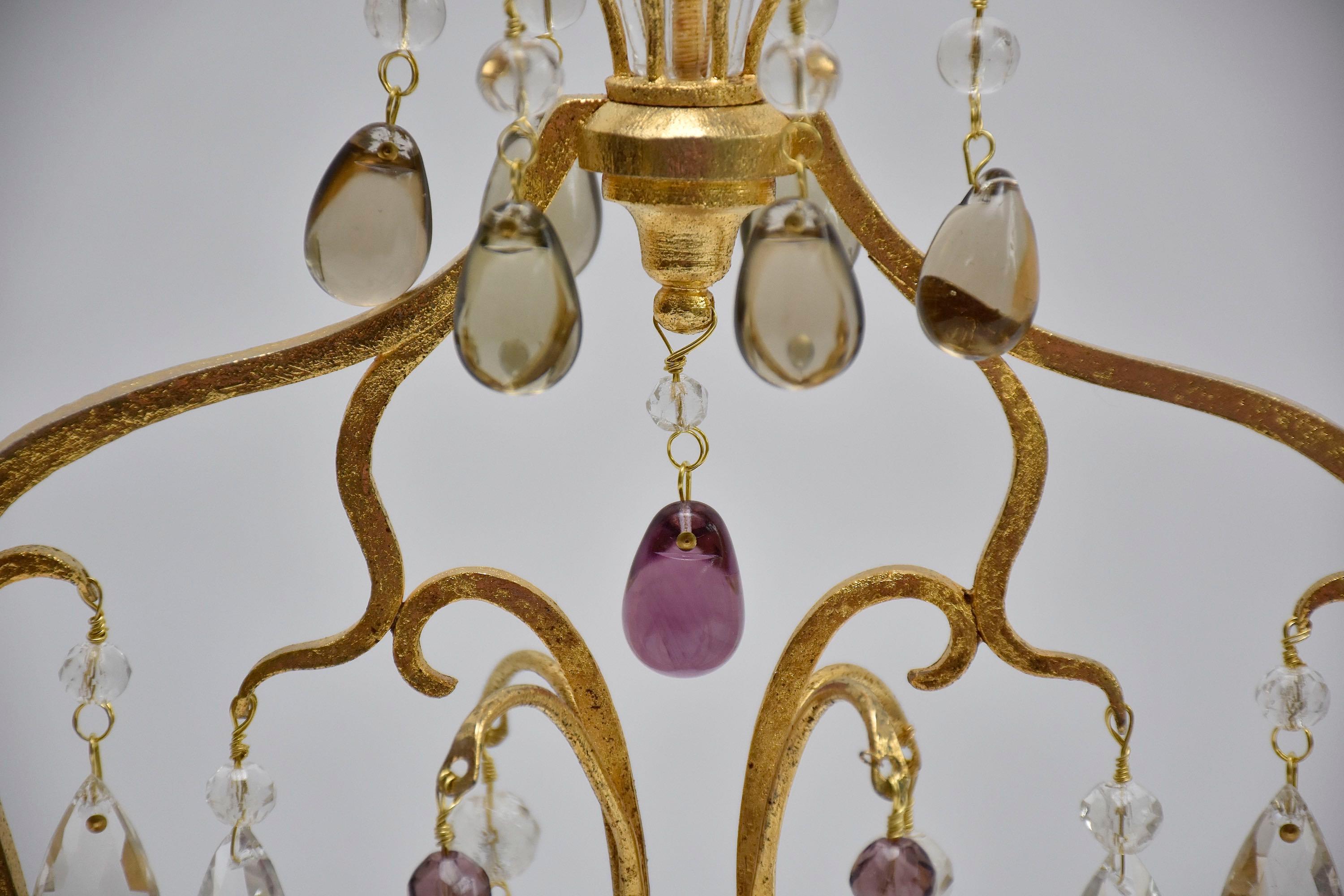 A wonderful pair of large girandoles attr. to the famous French company Maison Baguès.
Each with 3 candle arms. Beautiful and rich decoration of clear and soft coloured crystal pendants like grapes and flowers.
The crystal bobeches are champagne