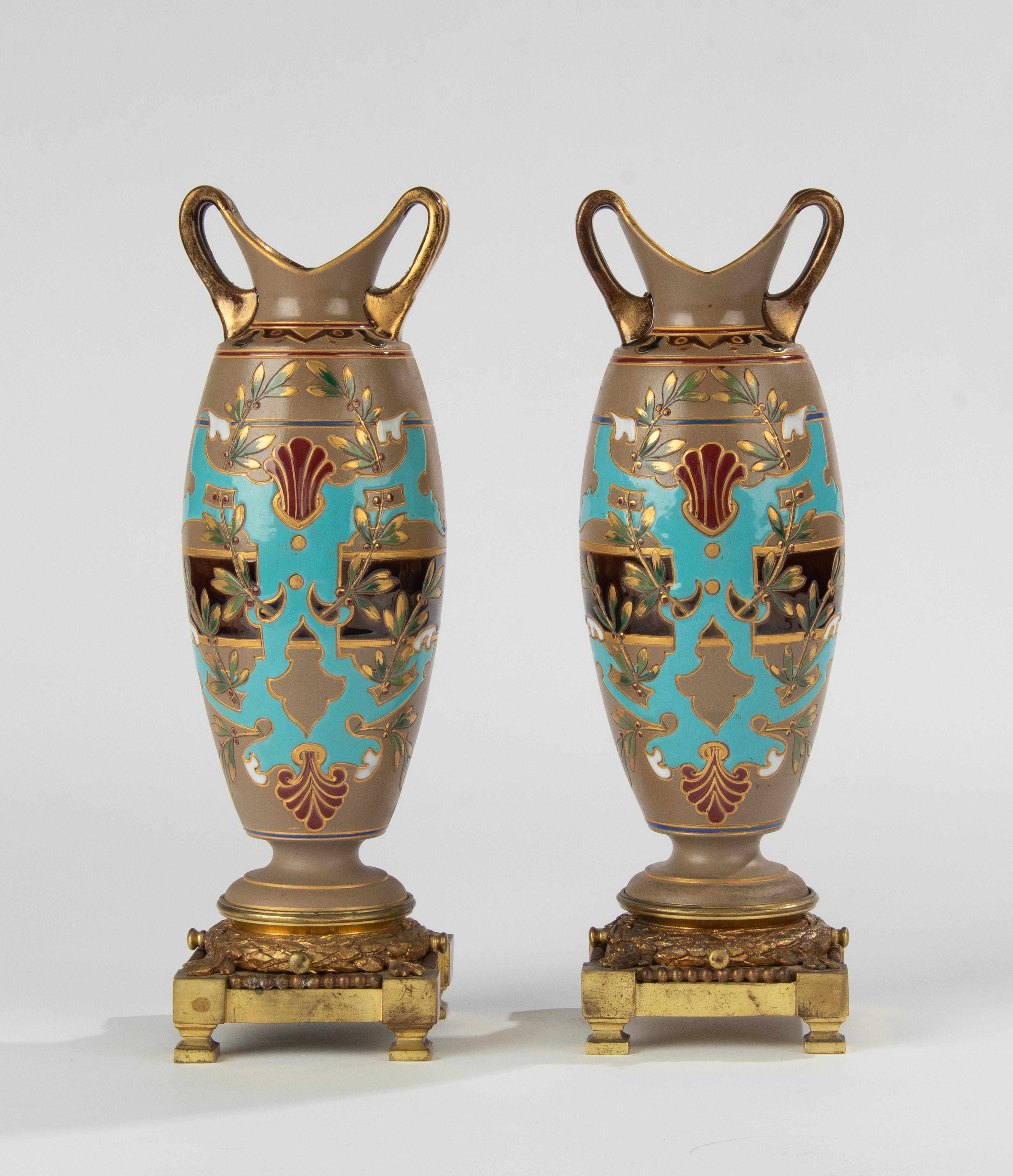 A beautiful pair of ceramic majolica vases with bronze base, made by the French brand Sarregumines.
The ceramic part is nicely designed with special colors. The bronze base is gilded.
The bottom of the vases are marked.
The vases are in very good