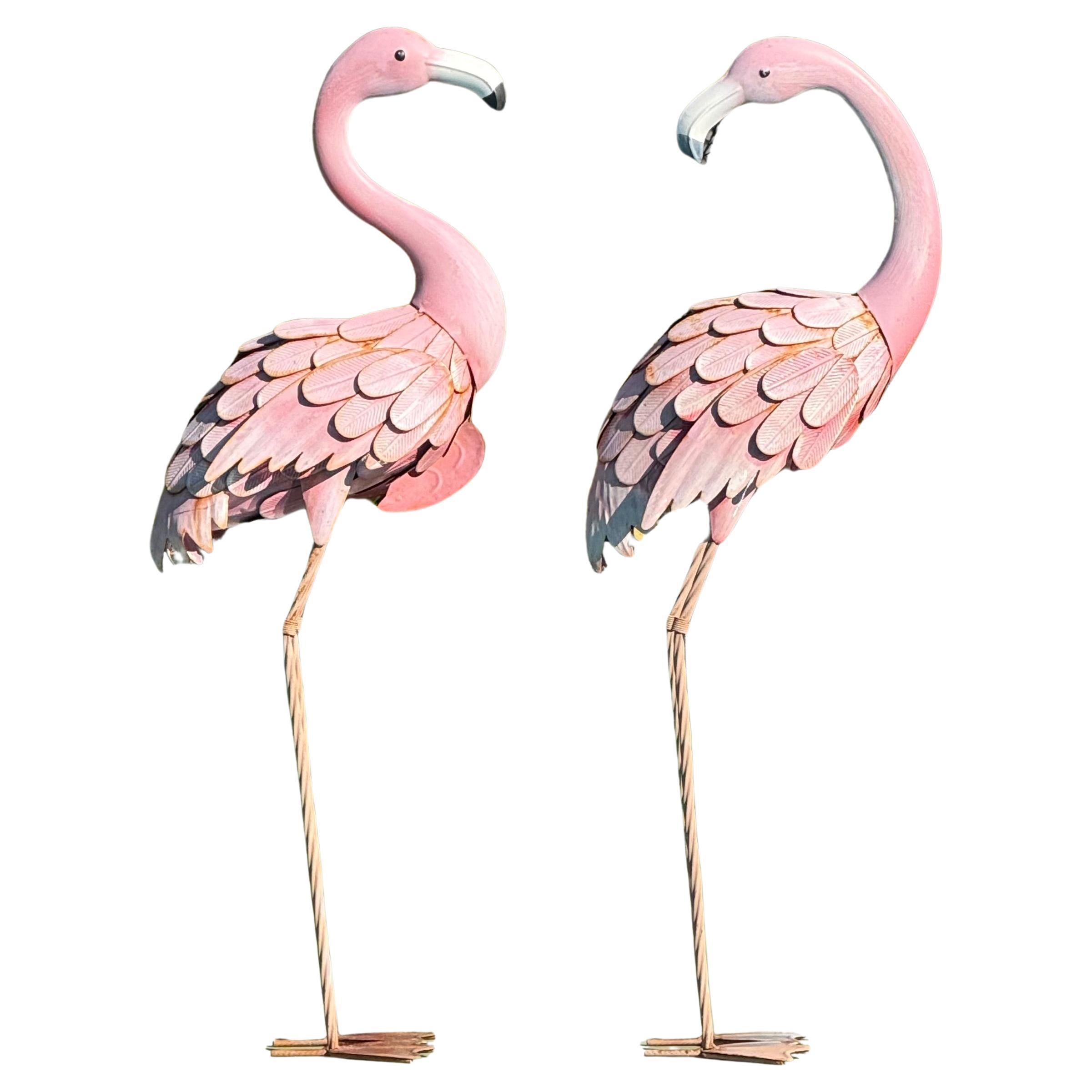 A pair of antique metal flamingo sculptures, circa 1950