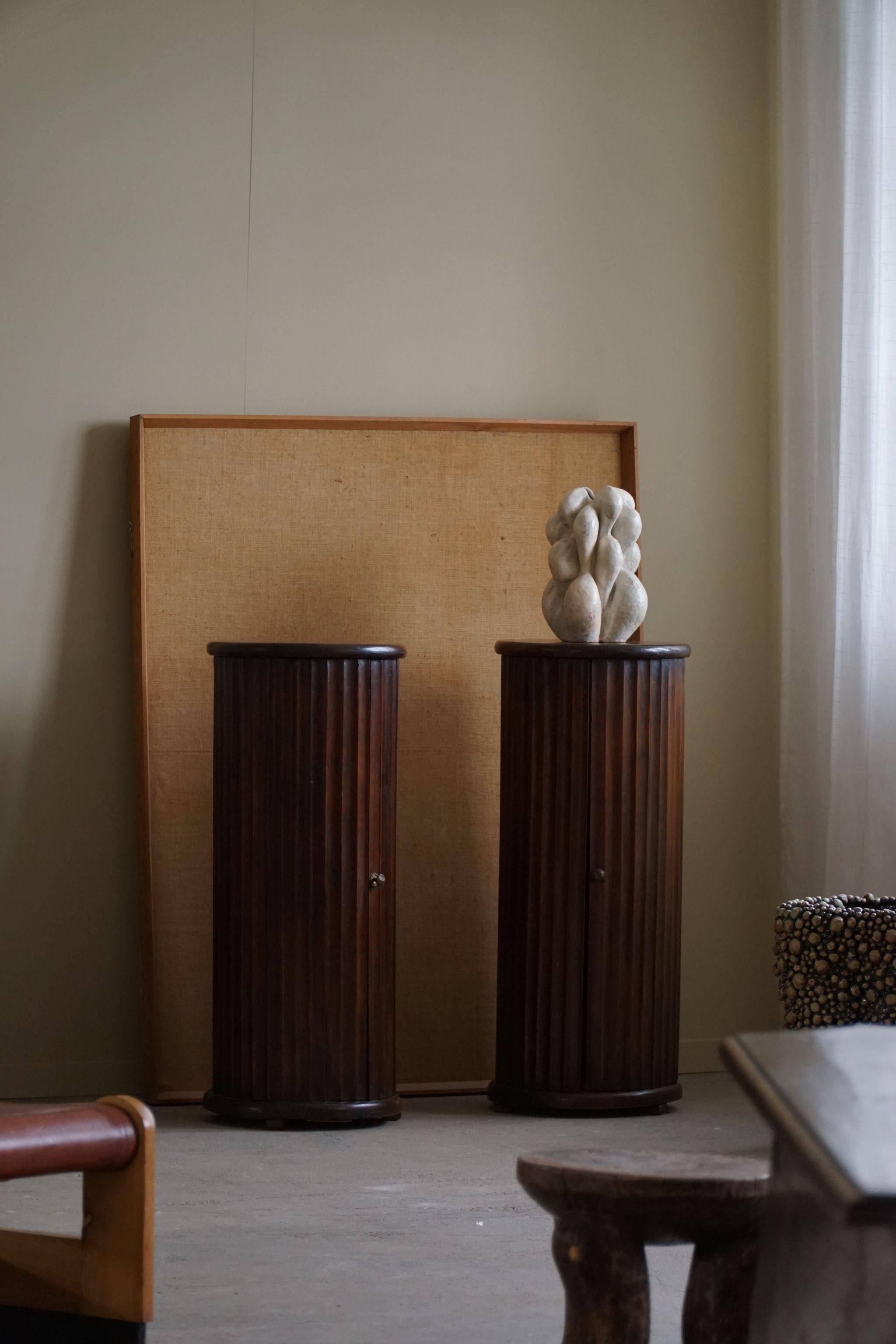 A charming pair of antique pedestals crafted in the late 19th century by an Italian cabinetmaker. Made from rich nutwood, they feature a beautifully grooved carved front design. Not just some elegant accents, these pedestals also offer practicality