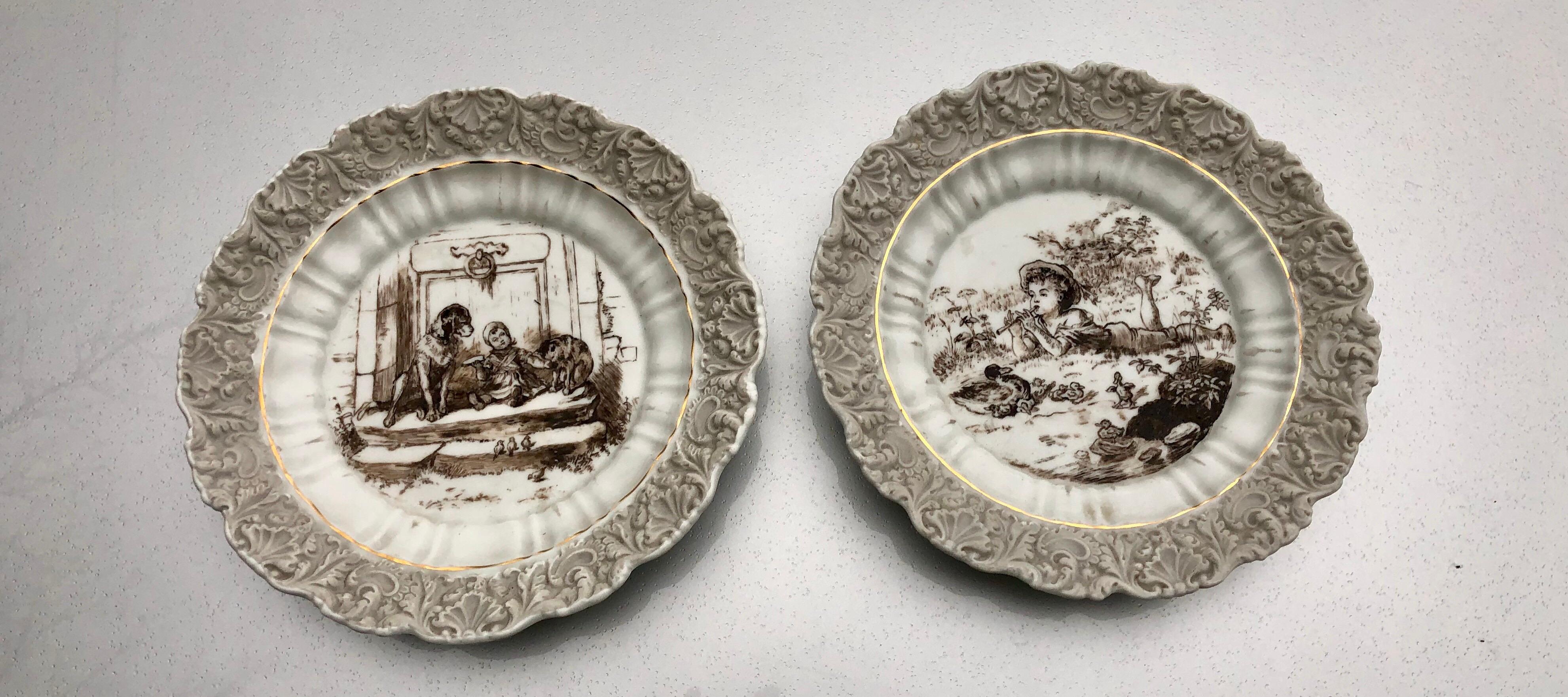 A pair of antique pretty boy and girl porcelain plates hand painted, KPM Germany.