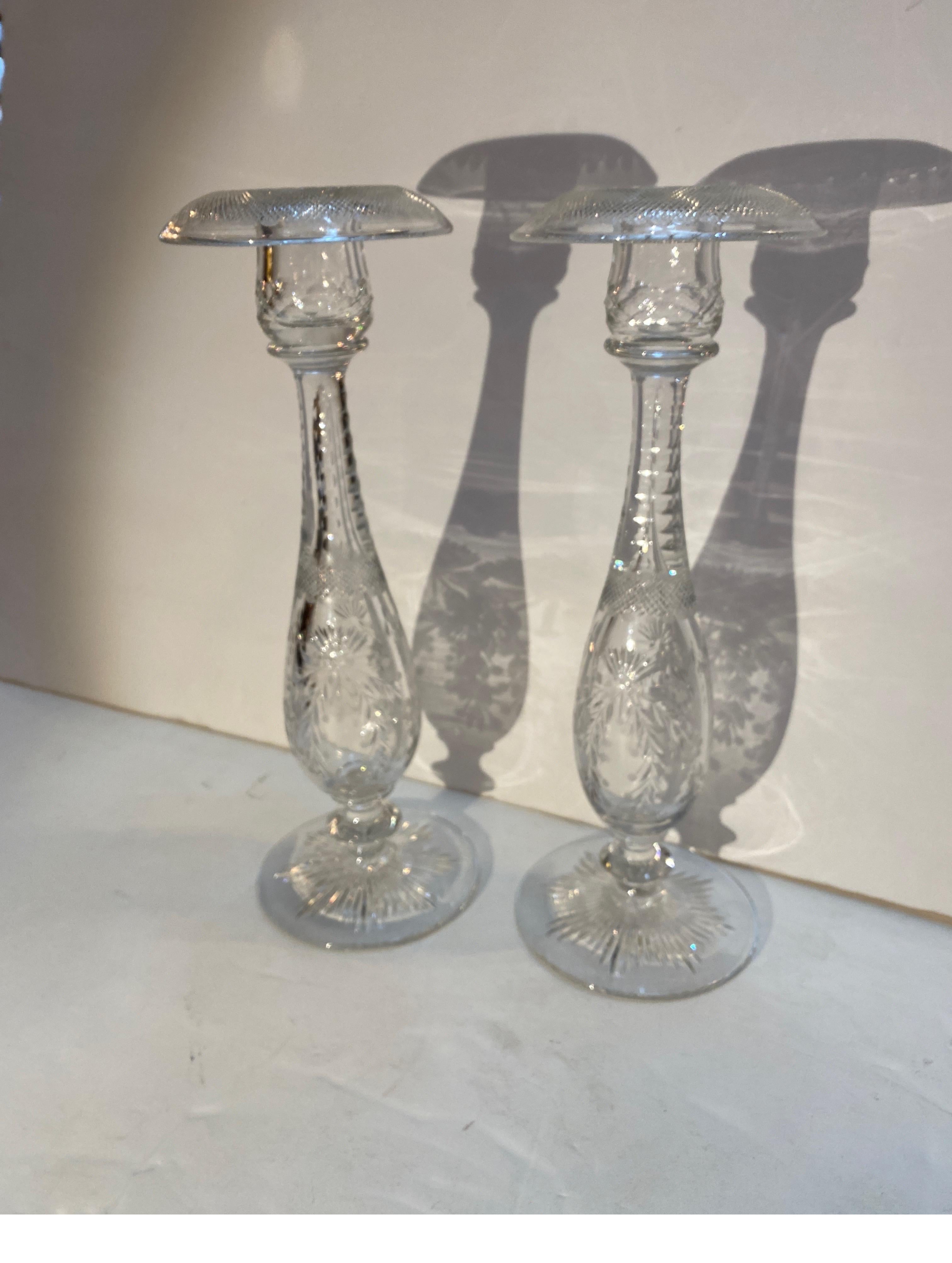 An elegant pair of 12 inch tall cut and engraved glass candlesticks by Sinclair. Perfect condition, beautifully hand blown and engraved, Circa 1910.