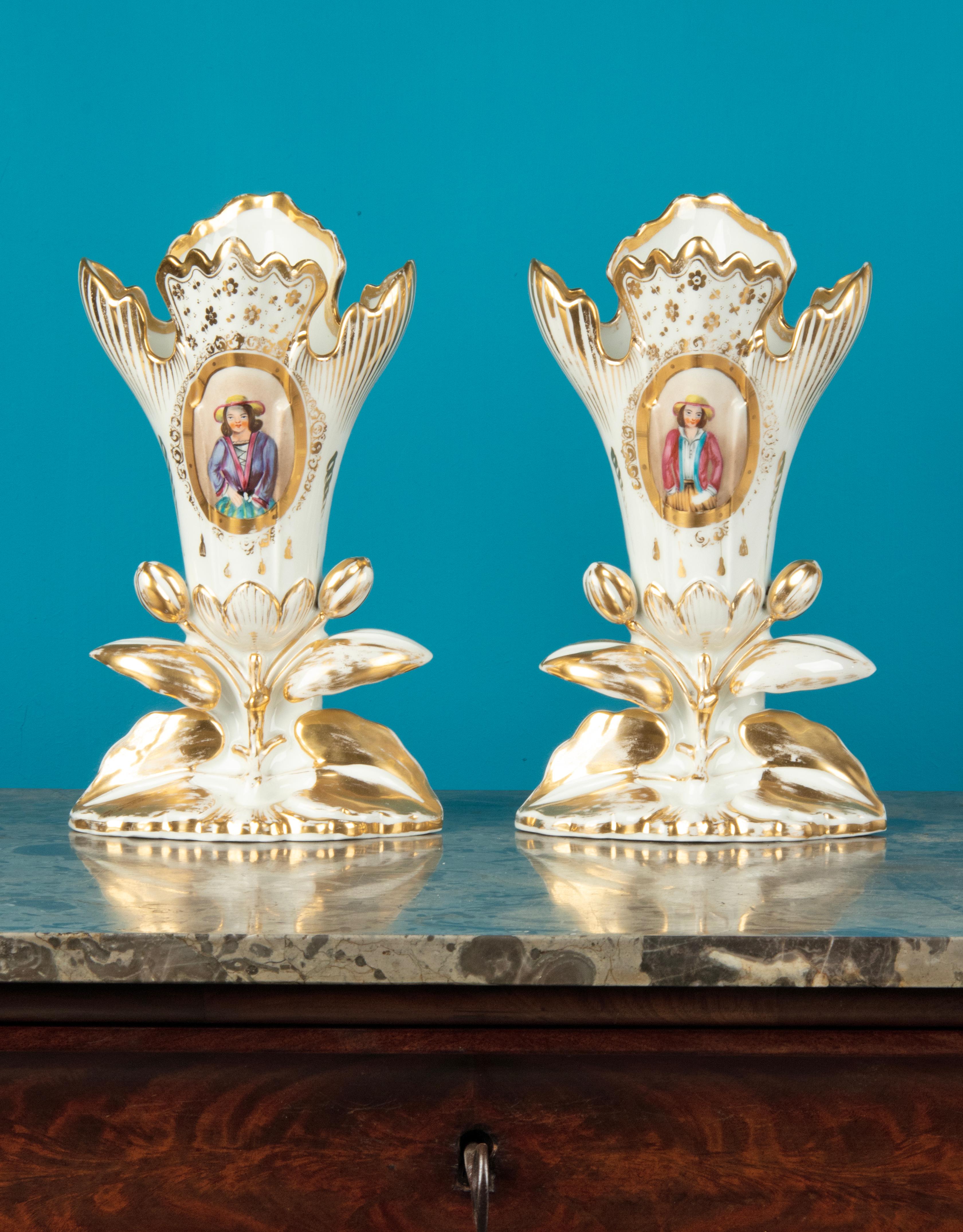 A lovely pair of antique porcelain Vieux Paris vases. Hand painted with portraits of a boy and a girl and gold colored accents. The vases are in good condition. No chips and no hairlines. Light wear on the gold colored accents. The vases date from