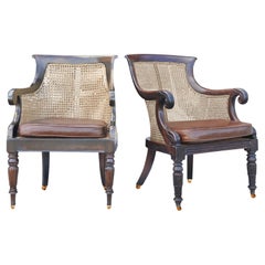 A Pair of Antique William IV Hardwood Cane Bergere & Leather Library Armchairs