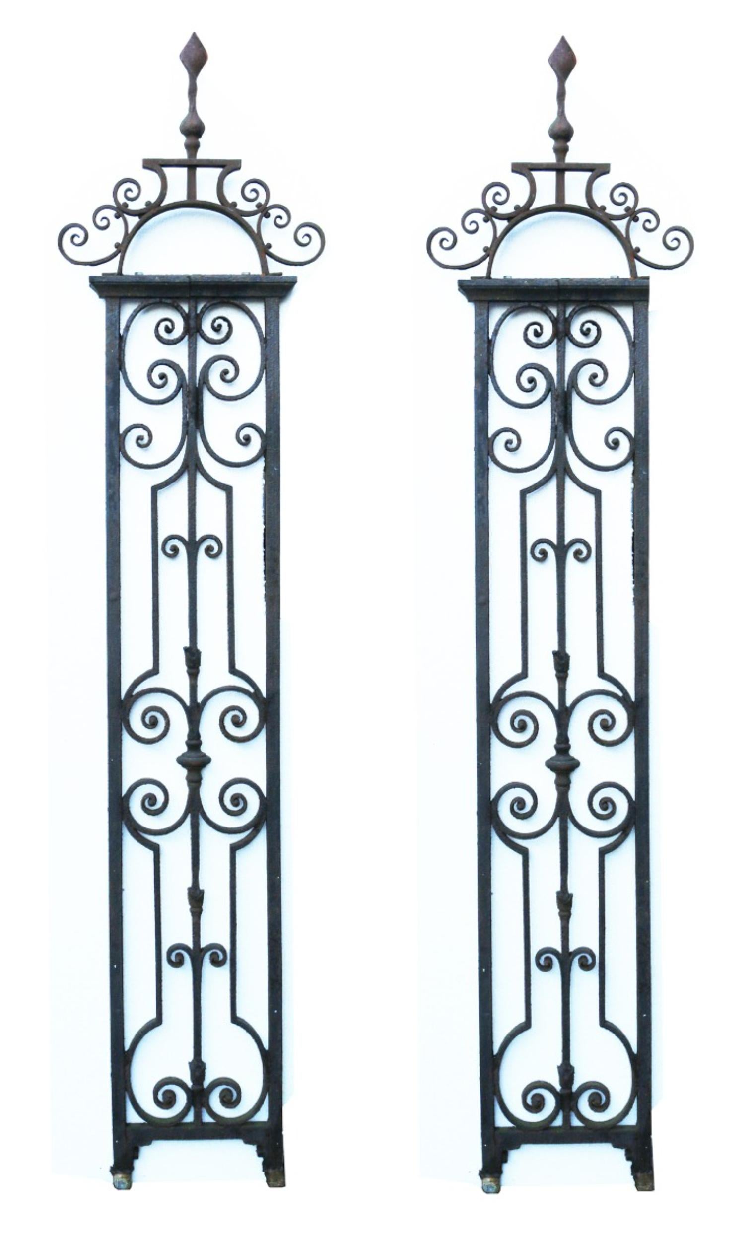 A pair of reclaimed Blacksmith made wrought iron posts, originally used to hang a pair of driveway gates. These currently have no hinge components attached.

Additional dimensions:

Each:

Height 245cm

Width 36cm-53cm

Depth 25cm.