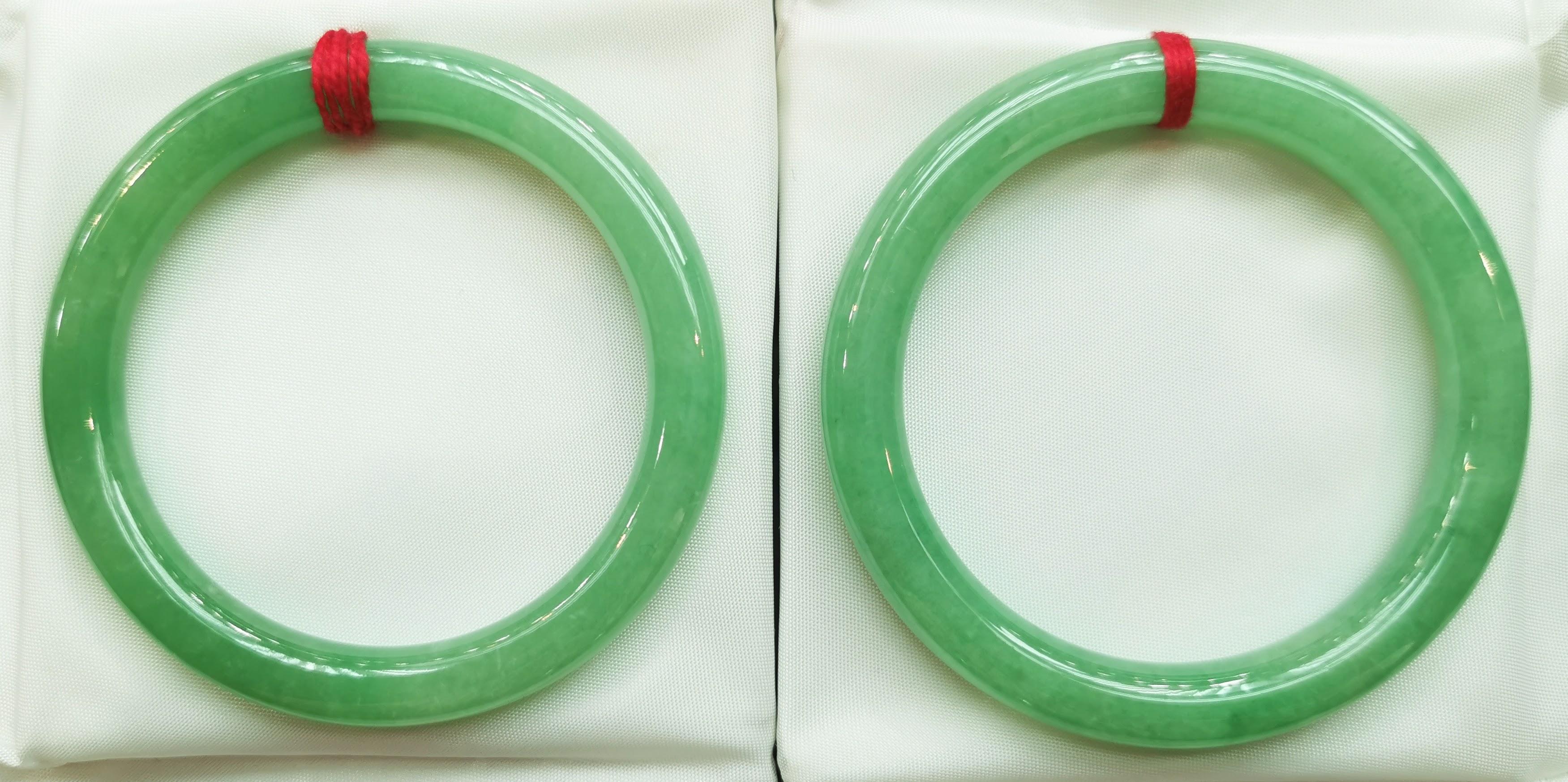 Introducing our exquisite Pair of Translucent Apple Green Jadeite Jade Bangles, a testament to the unparalleled beauty and rarity of fine jadeite craftsmanship. These bangles showcase a captivating apple green color with a translucent quality,