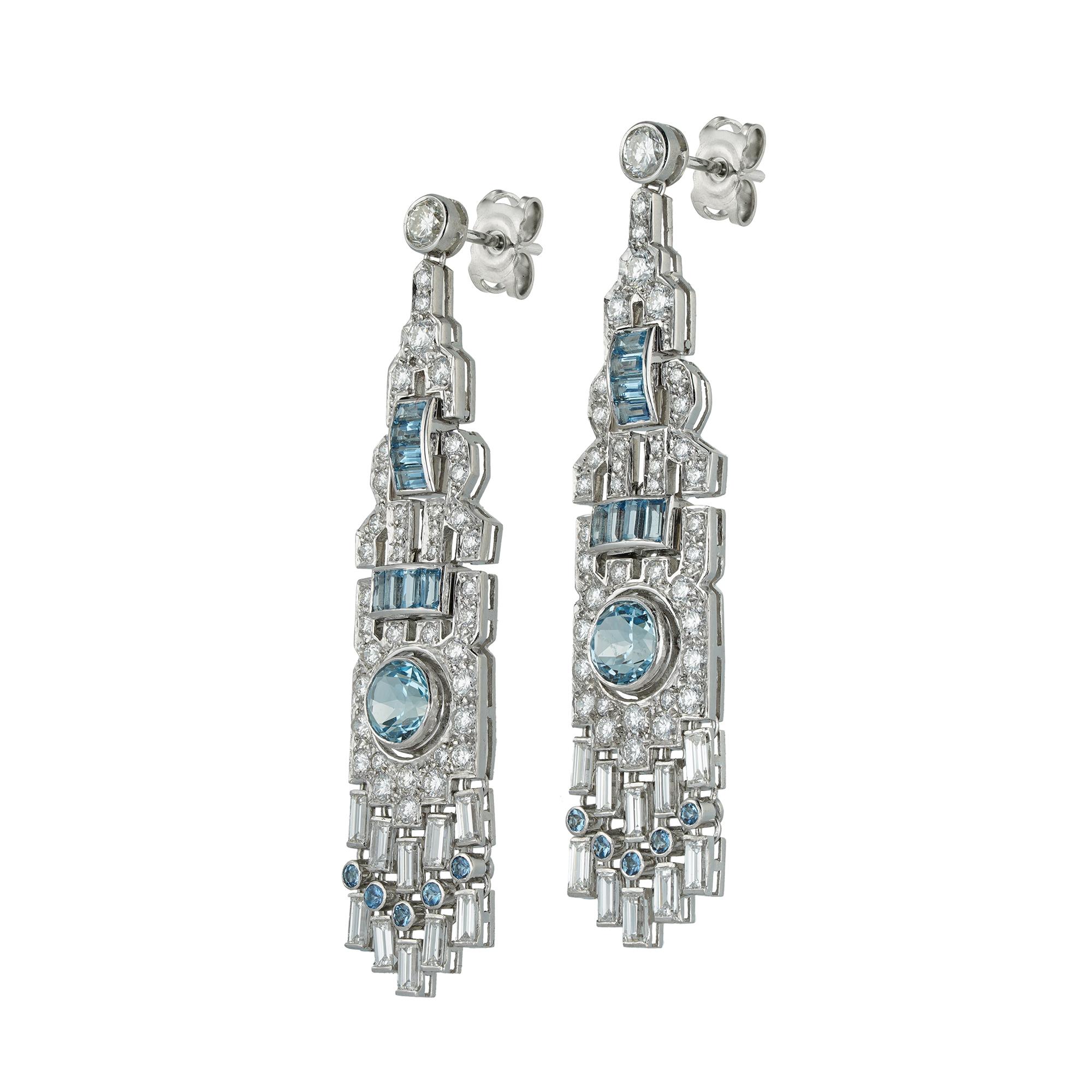 A pair of aquamarine and diamond drop earrings, each earring set with a round faceted aquamarine centre, weighing a total of 1.40 carats in total, to a round brilliant-cut diamond and baguette-cut aquamarine-set geometric openwork drop surround, to