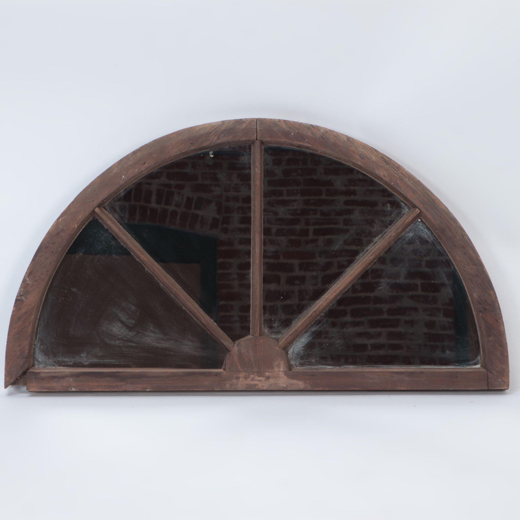 A pair of arched transome windows with later mirrors C 1900.