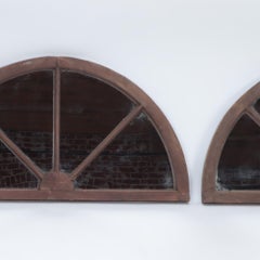 A pair of arched transom windows with later mirrors, C. 1900.
