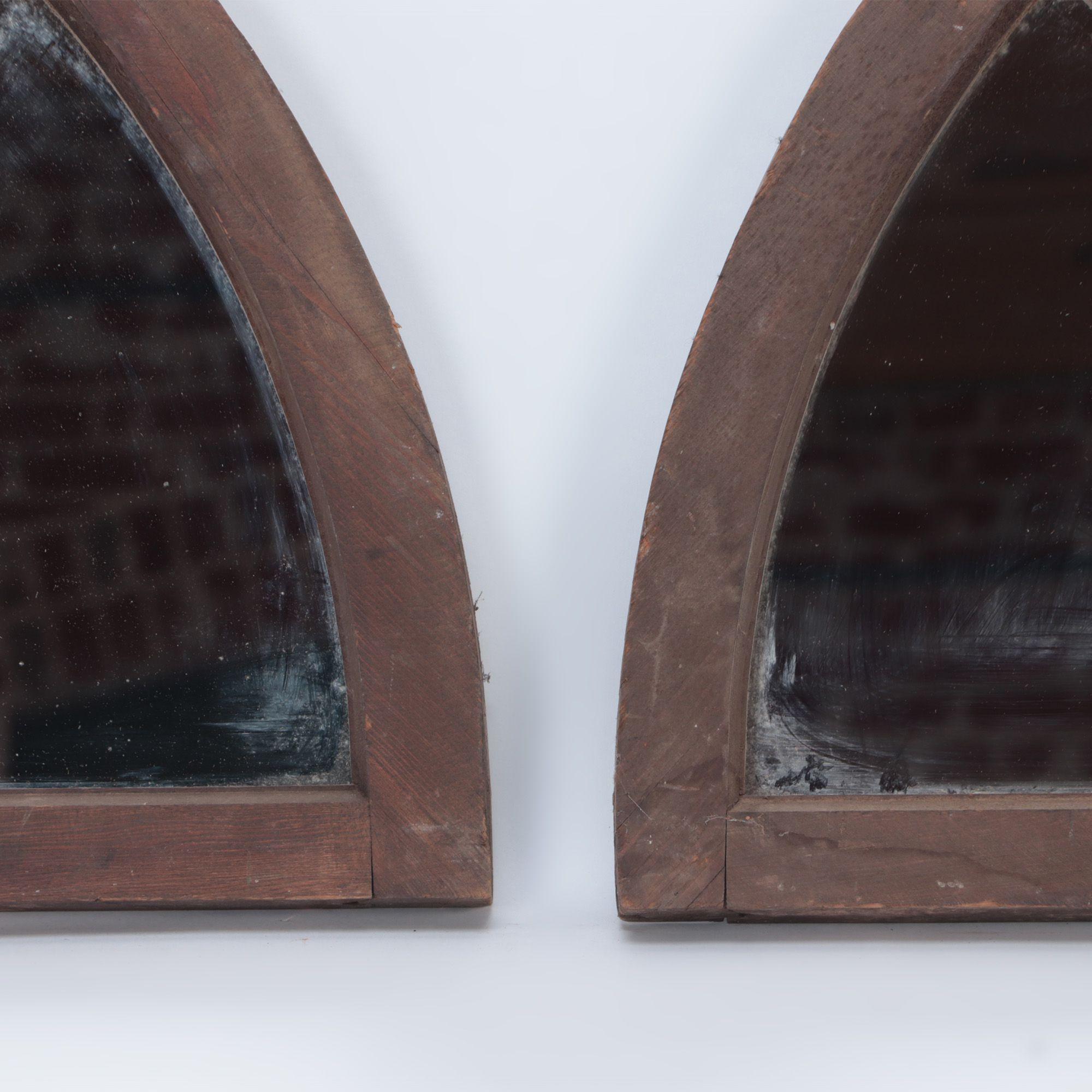 Wood A pair of arched transome windows with later mirrors C 1900 For Sale