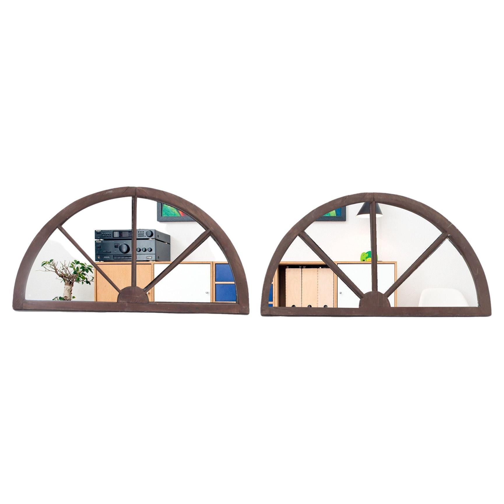 A pair of arched transome windows with later mirrors C 1900
