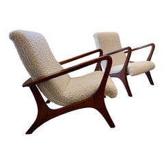 A pair of architectural design armchairs in lambswool boucle