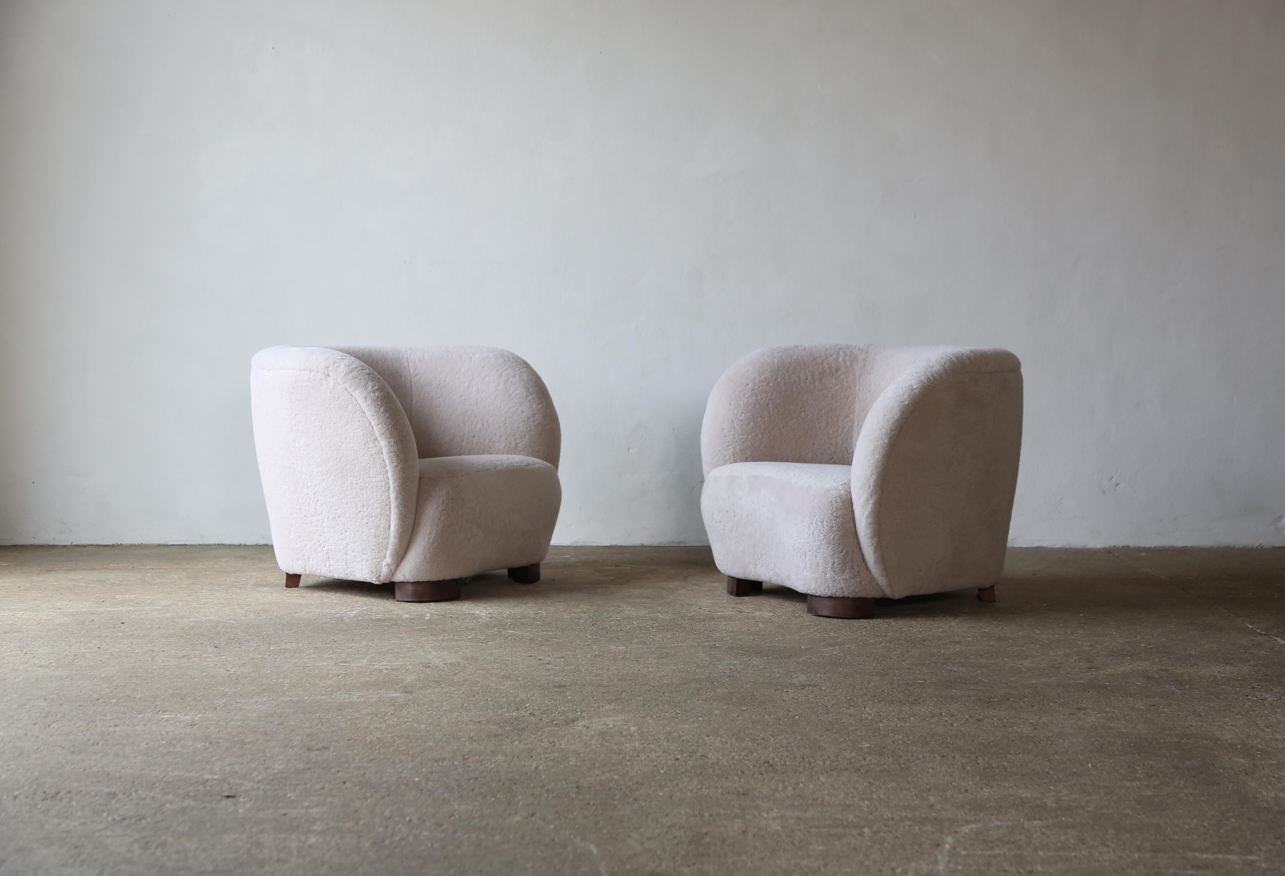 A beautiful pair of modern armchairs, in the style of Flemming Lassen / Viggo Boesen, upholstered in natural sheepskin.  Handmade beech frames and sprung seats.  Available in COM.  Fast shipping worldwide.



