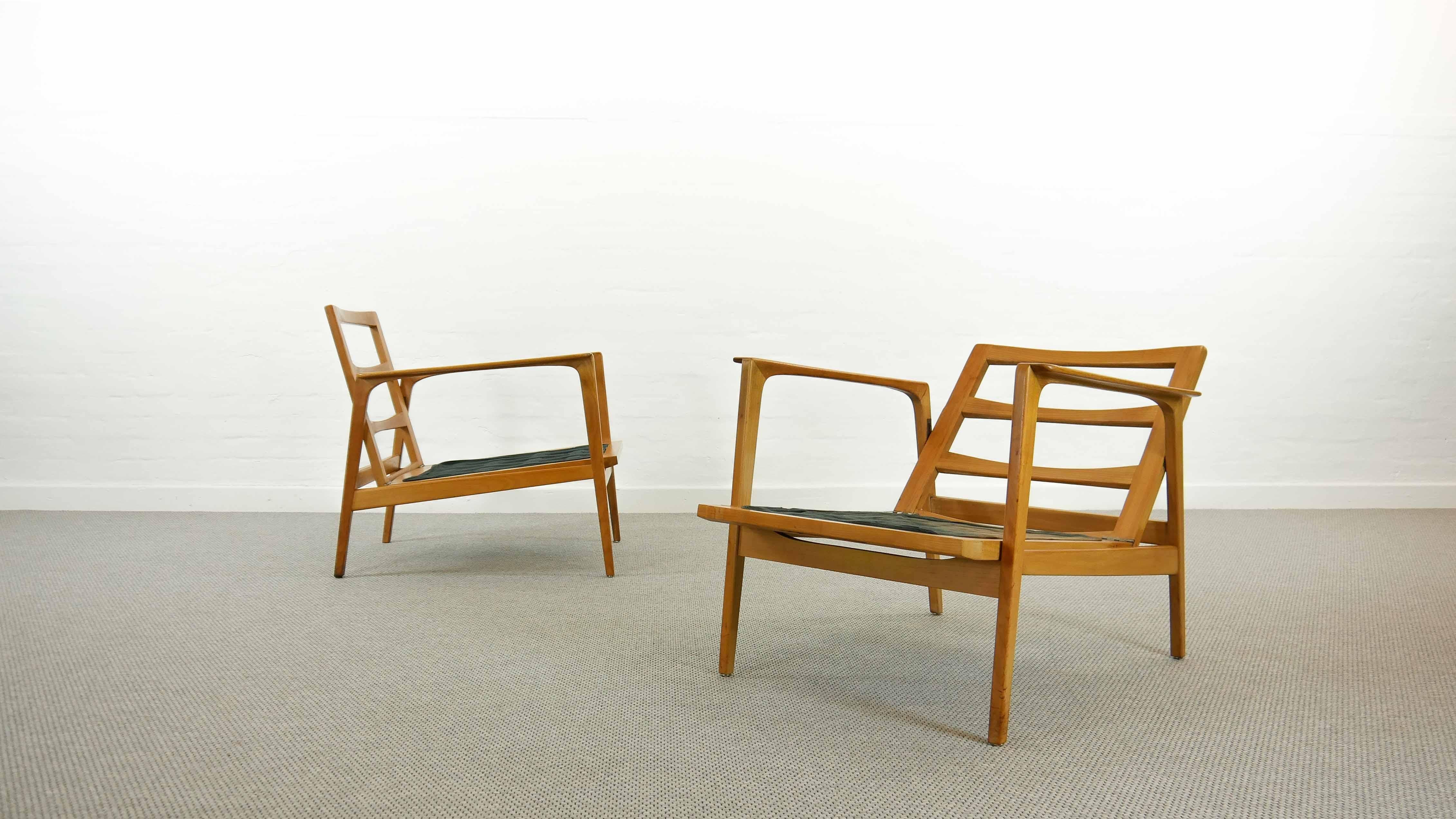 A pair of convertible modern midcentury chairs from Germany.
Made of solid beech and upholstered with the original wool garment.
A nice example of German Craftsmanship of the 1960s.

They were part of the 2019 Exhibition of the: Museum